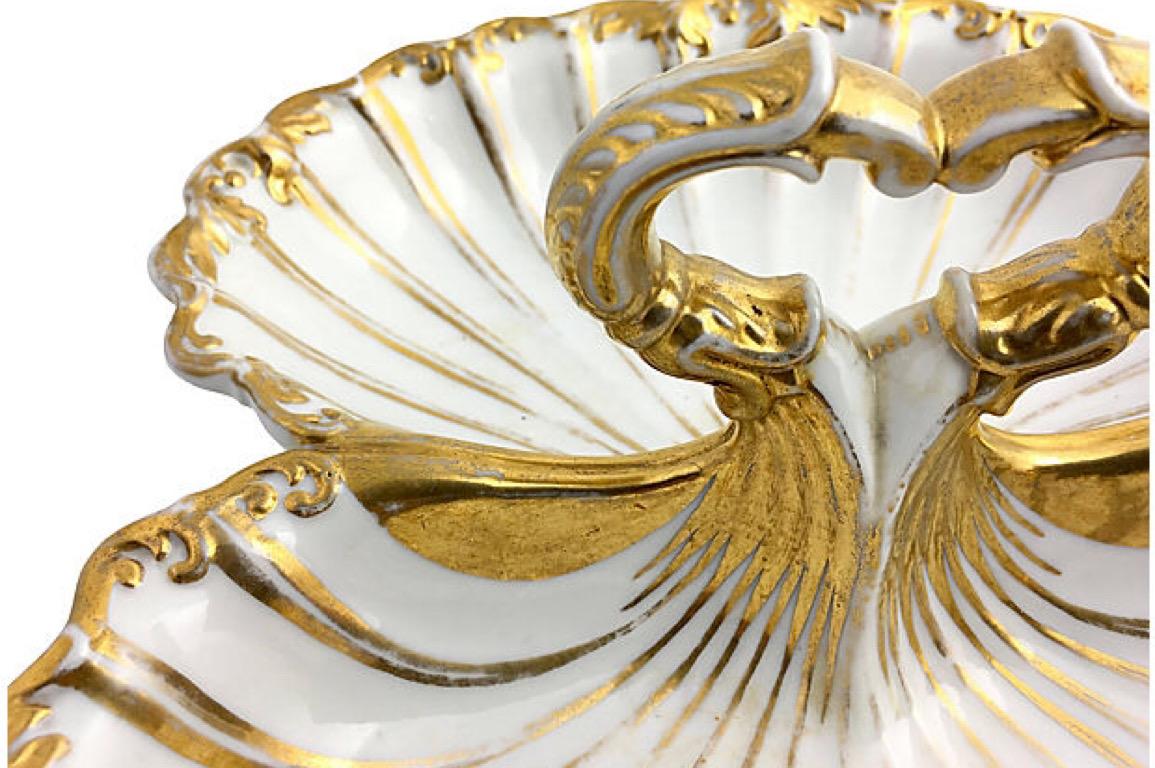 Antique Moabit divided serving bowl with handle and gilded accents. Berlin-based Moabit was founded by M. Schumann and son circa 1835 and was around until, circa 1913. Marked SPM on underside. The gold paint is faded in some areas. Gilt faded
