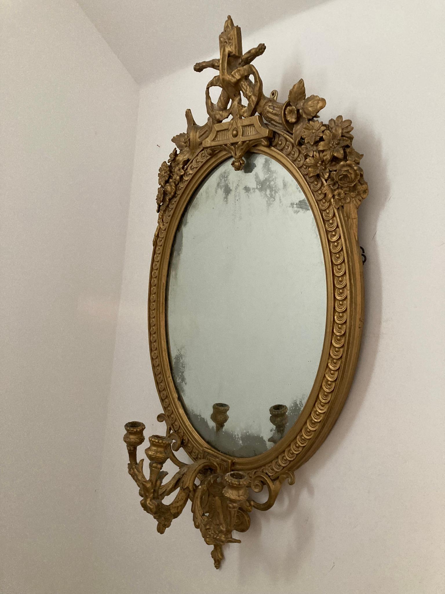A beautiful Antique Gilt Gesso Girandole Mirror in its original condition. Dating back to mid 19th Century. Foliate display around the frame and beaded edging each side with triple stemmed griandole at the base of the mirror. Original back with a