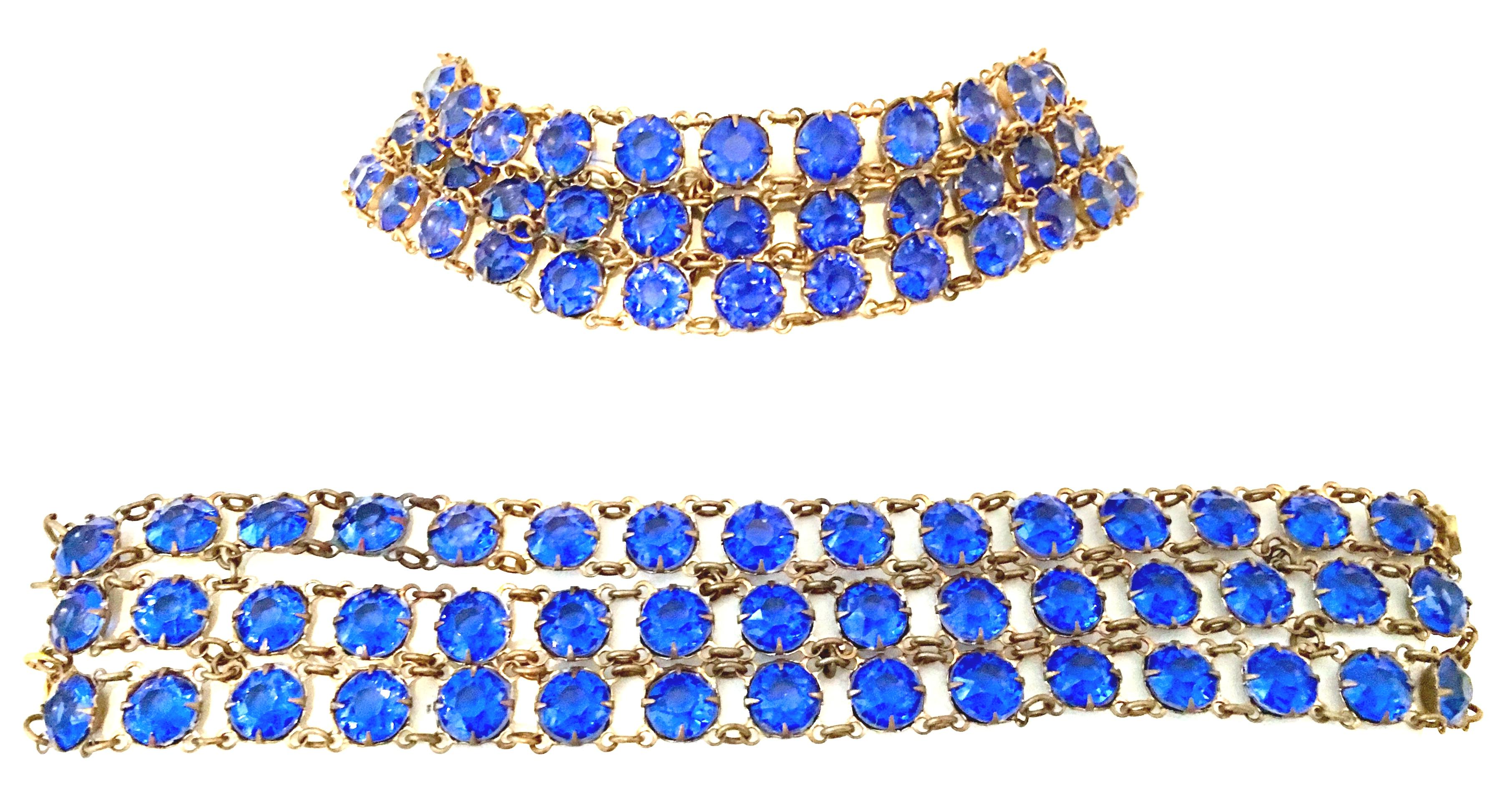 Antique European Sapphire Blue Faceted Glass & Gold Brass Multi - Strand Choker Style Necklace And Bracelet Set. Each piece features three rows of chain link brass with open back prong set stones. The necklace is 
