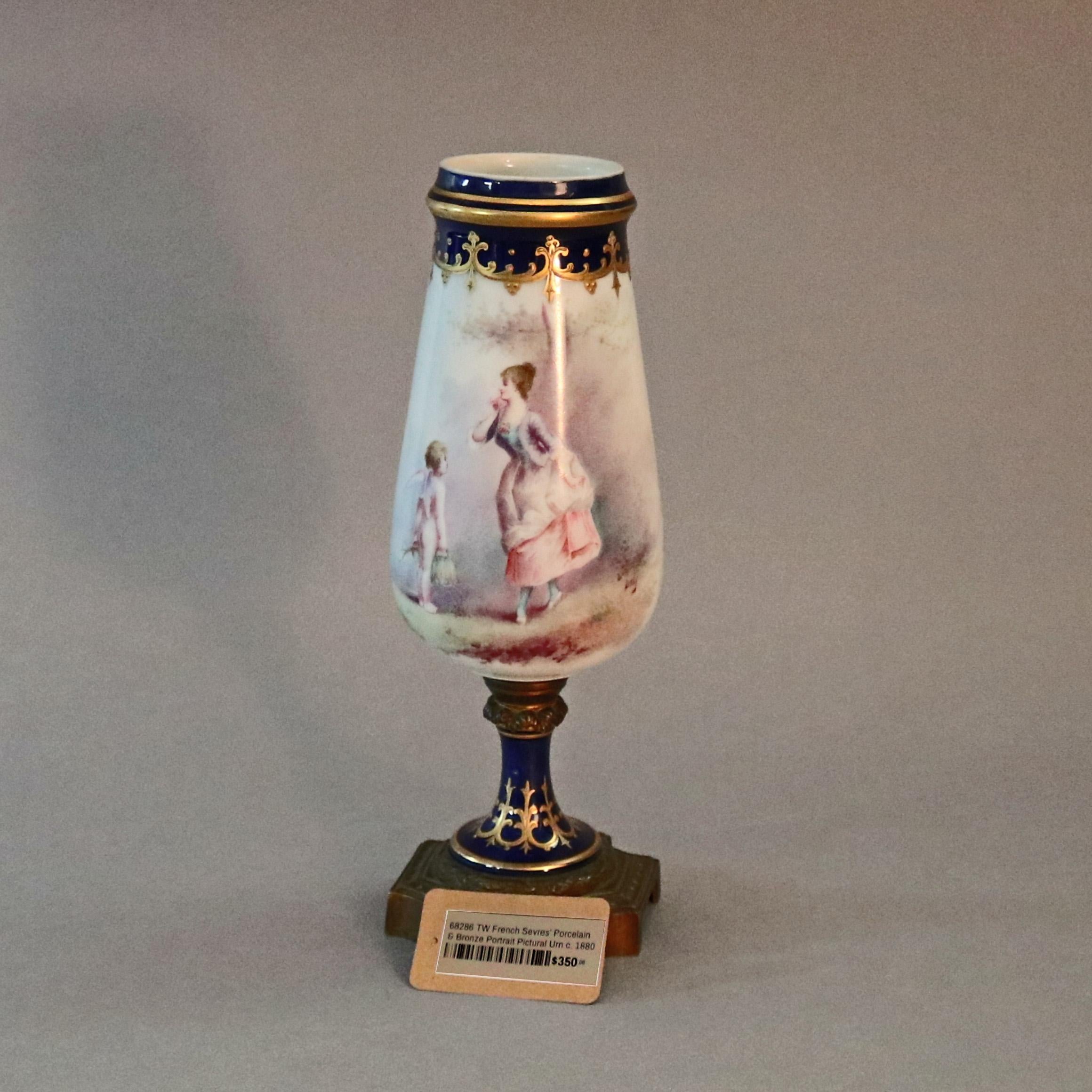 An antique French Sevres School pictorial porcelain open urn offers hand painted scene of young woman and cherub in countryside setting bordered in gilt decorated cobalt blue banding and seated on cast bronze base, circa 1880


Measures: 12