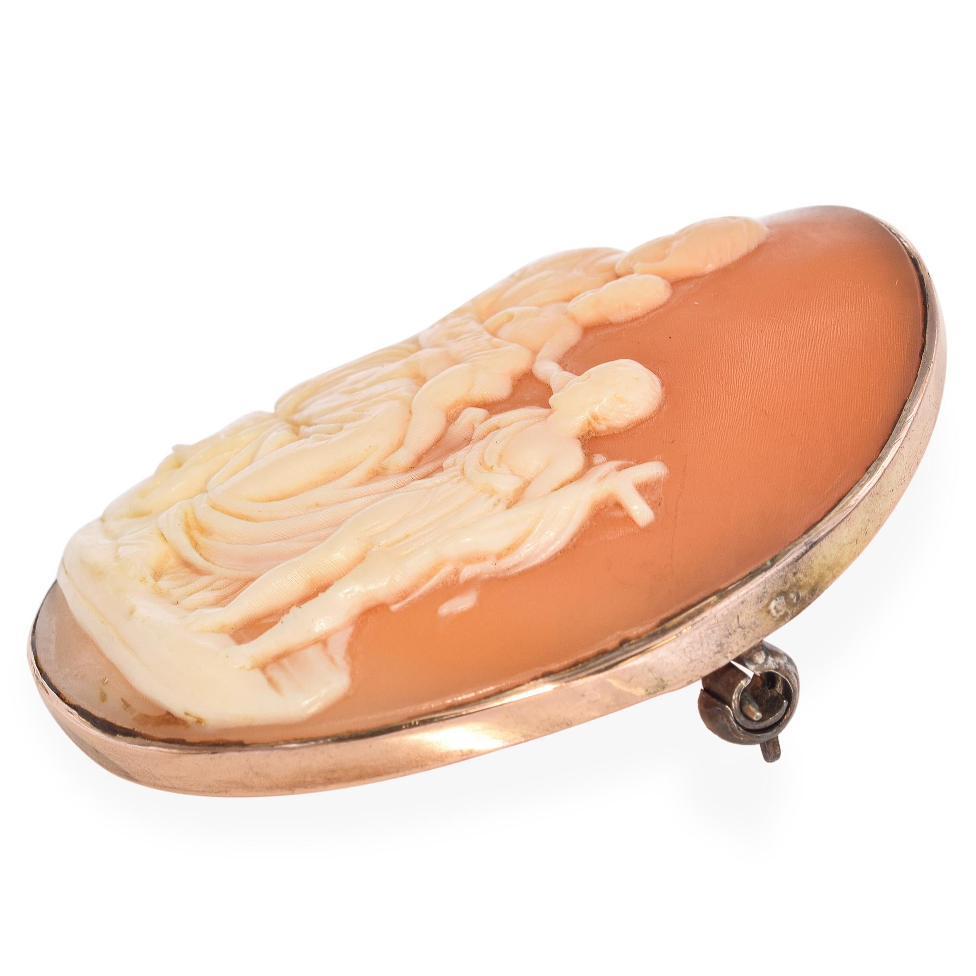 This touching antique cameo brooch features a finely carved depiction of Mary, Joseph, and young John the Baptist, rendered with gentle expressions and classical detail. Set in a warm Gold Plated frame, the piece reflects both religious reverence
