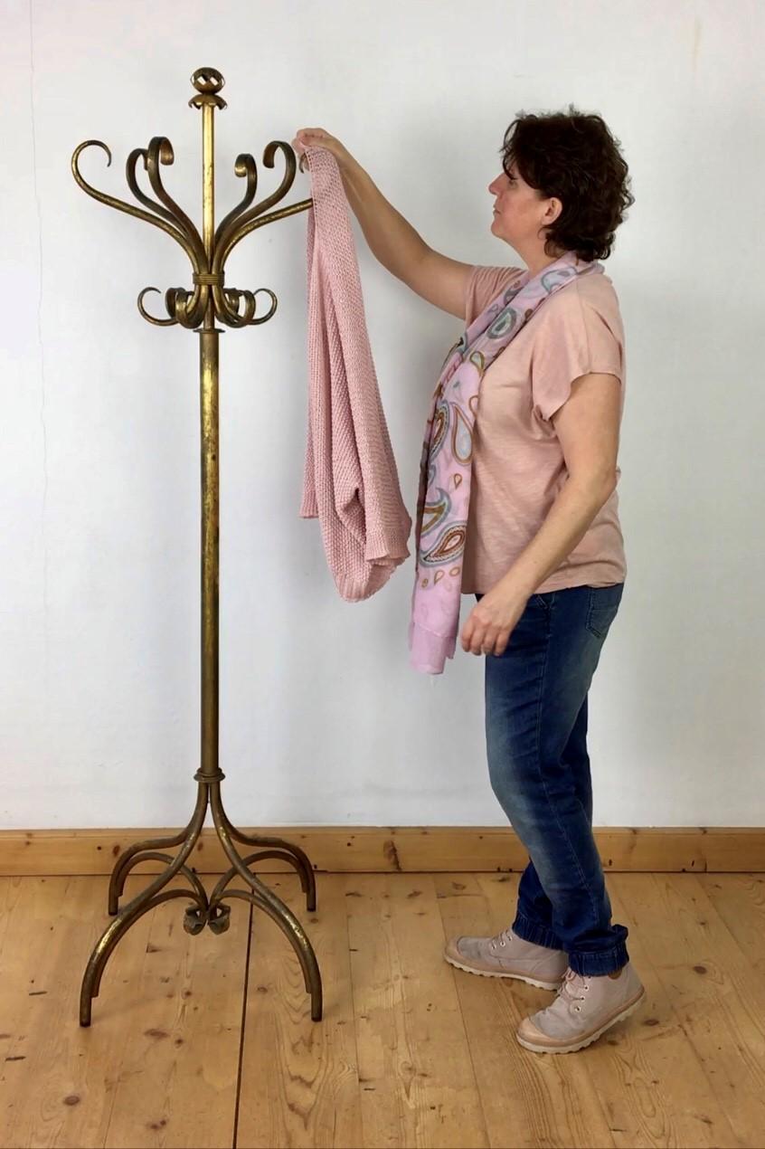 Antique gilt metal hat and coat stand. 
The gilt metal of this hall coat stand is still original so the gilt finish has in the meantime a great charming worn patina. Above you find a double layer of hooks to hang your coats and hats: 6 large and 6