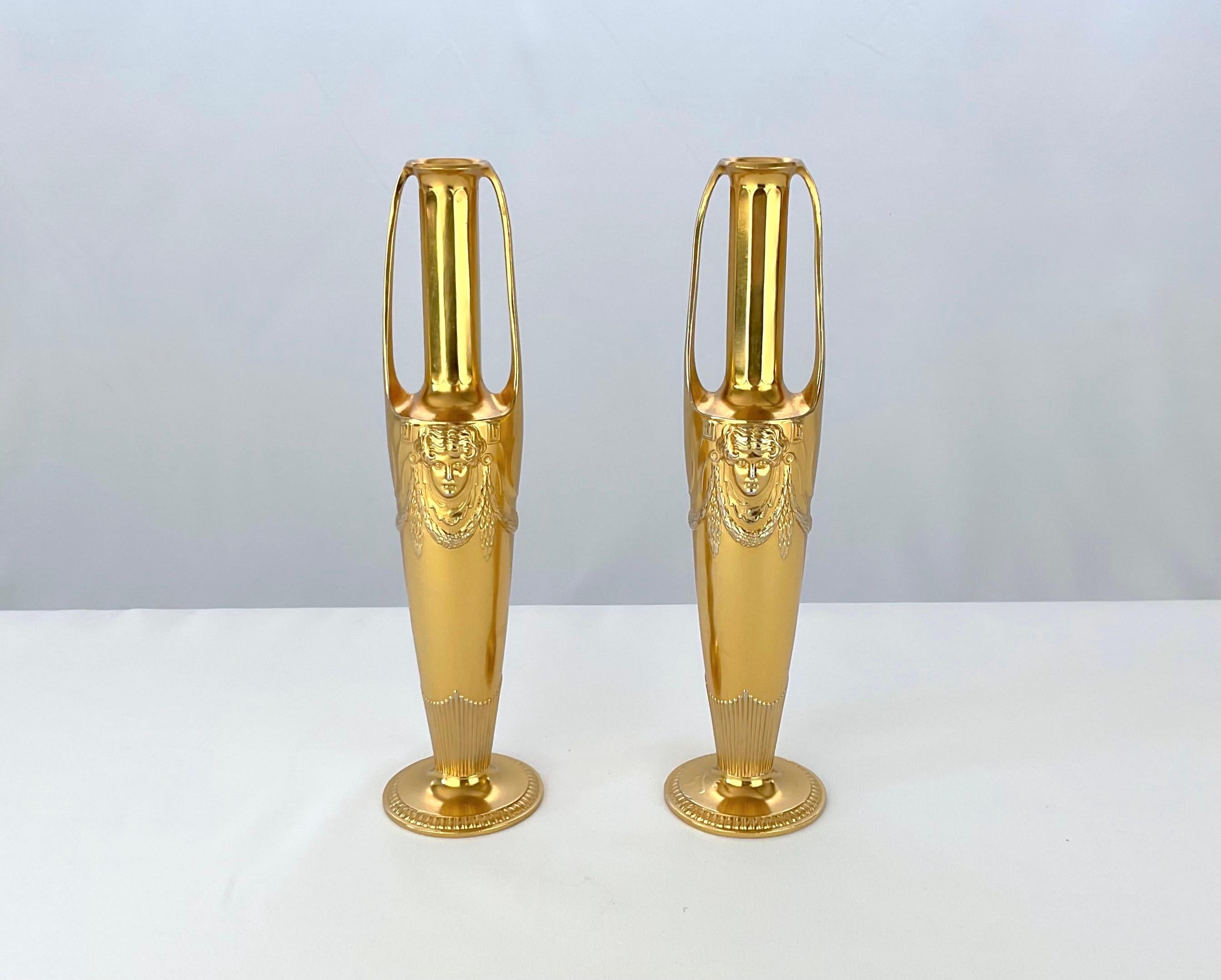 An antique two-handled gilt metal vase pair in the neoclassical style by Orivit-Metallwarenfabrik AG of Germany, dating to the Art Nouveau / Jugendstil period, circa 1905

The double-handled design resembles a slim and elegant urn. The gilded metal