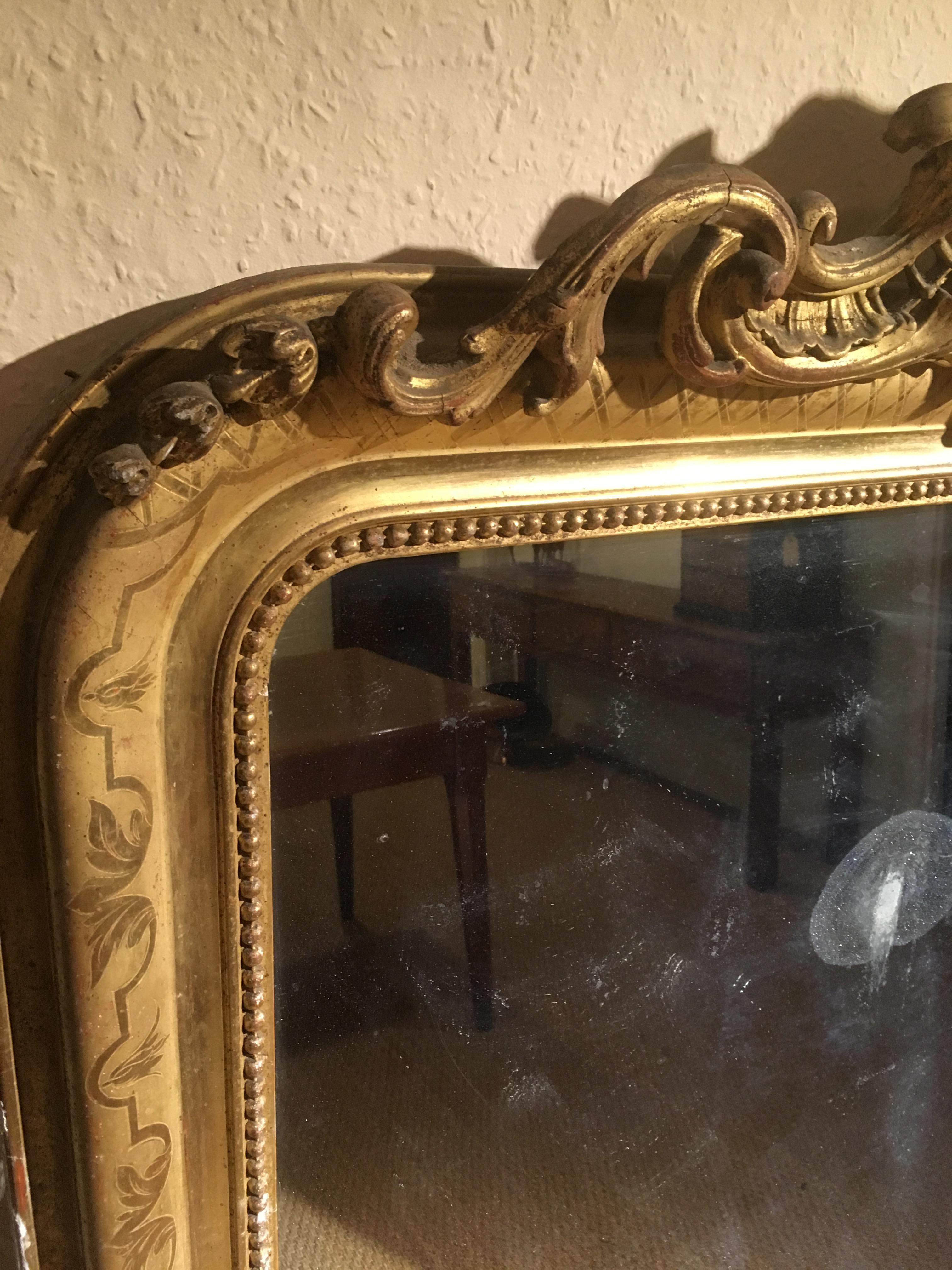 19th century gilt mirror 

Dating to around the 1860s this mirror could do with a bit of restoration mainly along the bottom strip , missing a couple of back boards , or does look good as is - country house look 

Measures: 42 inches wide or 107