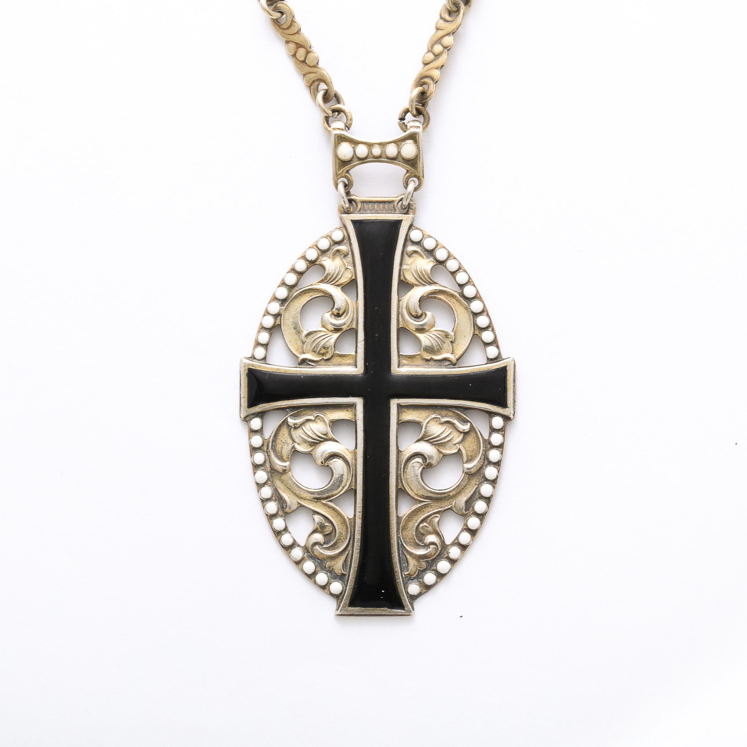 This exquisite Antique cross pendant features an open work stylized floral design decorated with black and white enamel suspended from the original link chain. This piece is signed IND .830 gilt silver. It in in excellent vintage condition .
Circa
