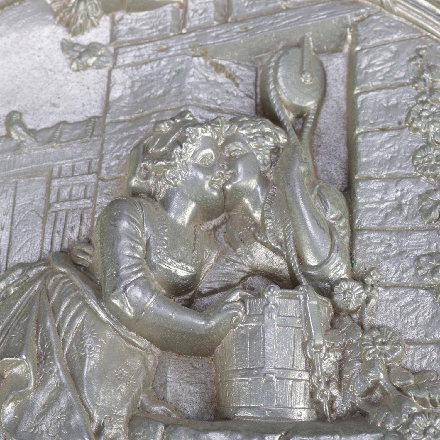 An antique gilt silver charger features central high relief courting scene 