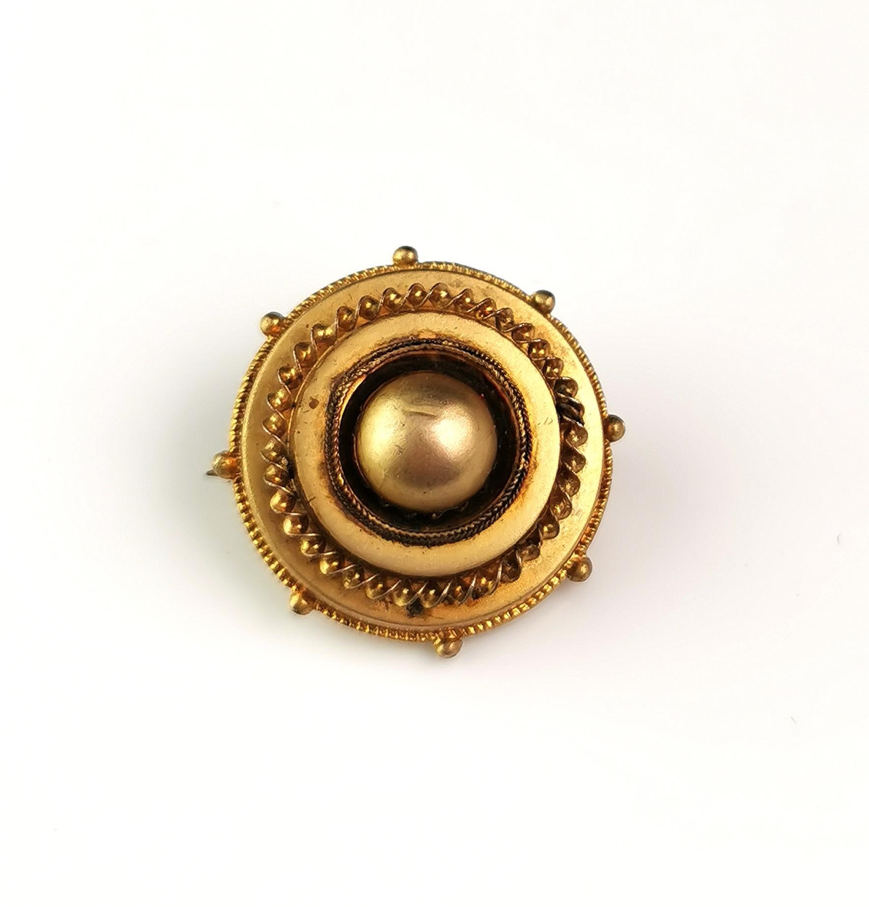 An attractive antique Victorian era gilt mourning brooch.

Designed in the target style it is crafted in a rich golden gilt metal with a lightly domed front and beading around the outer rim.

To the reverse there is a locket compartment enclosing a