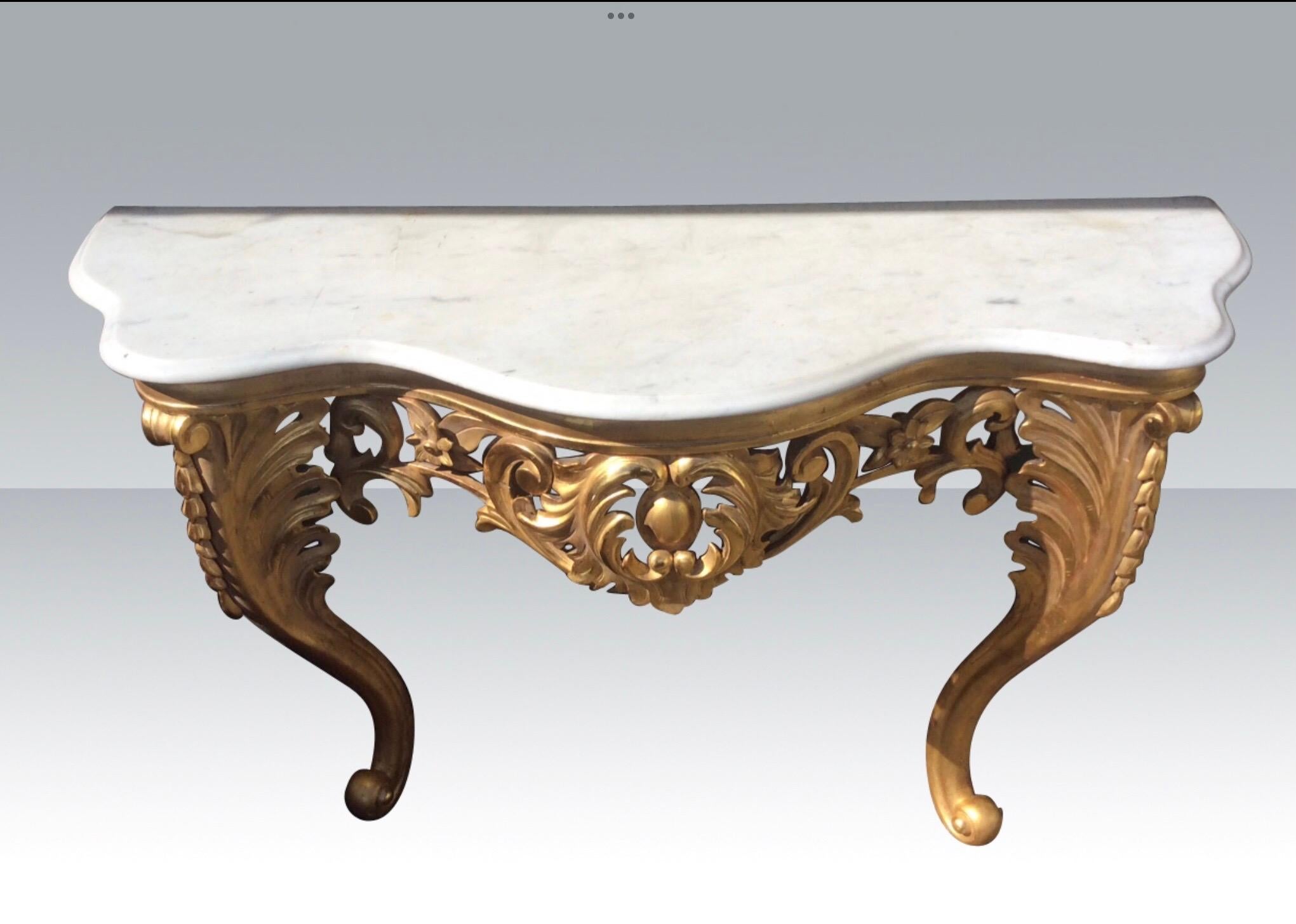Superb quality antique gilt wood carved console side table with Serpentined shaped white carrera marble top.
Excellent Condition.
Circa 1850
Measures: 55ins wide x 34ins high x 20ins Deep
(140cm x 86.5cm x 51cm deep).