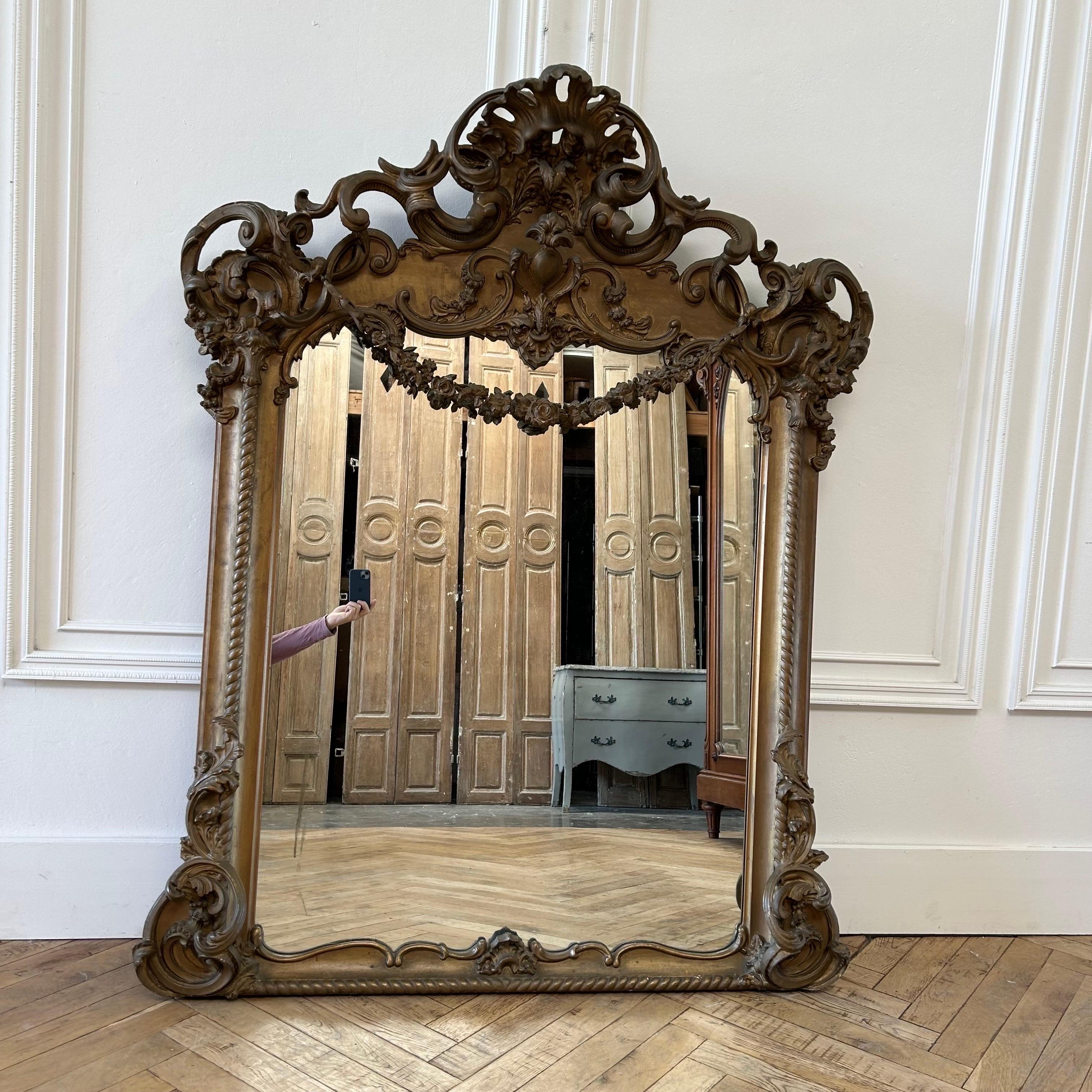 Antique French Rose swag mirror
Original gilt wood finish, subtle distressed edges.
Carvings are done in wood and gesso. The swag on the front of the mirror is detachable, and held onto the mirror with metal hooks.
Size: 50”w x 10”d x 63”h
