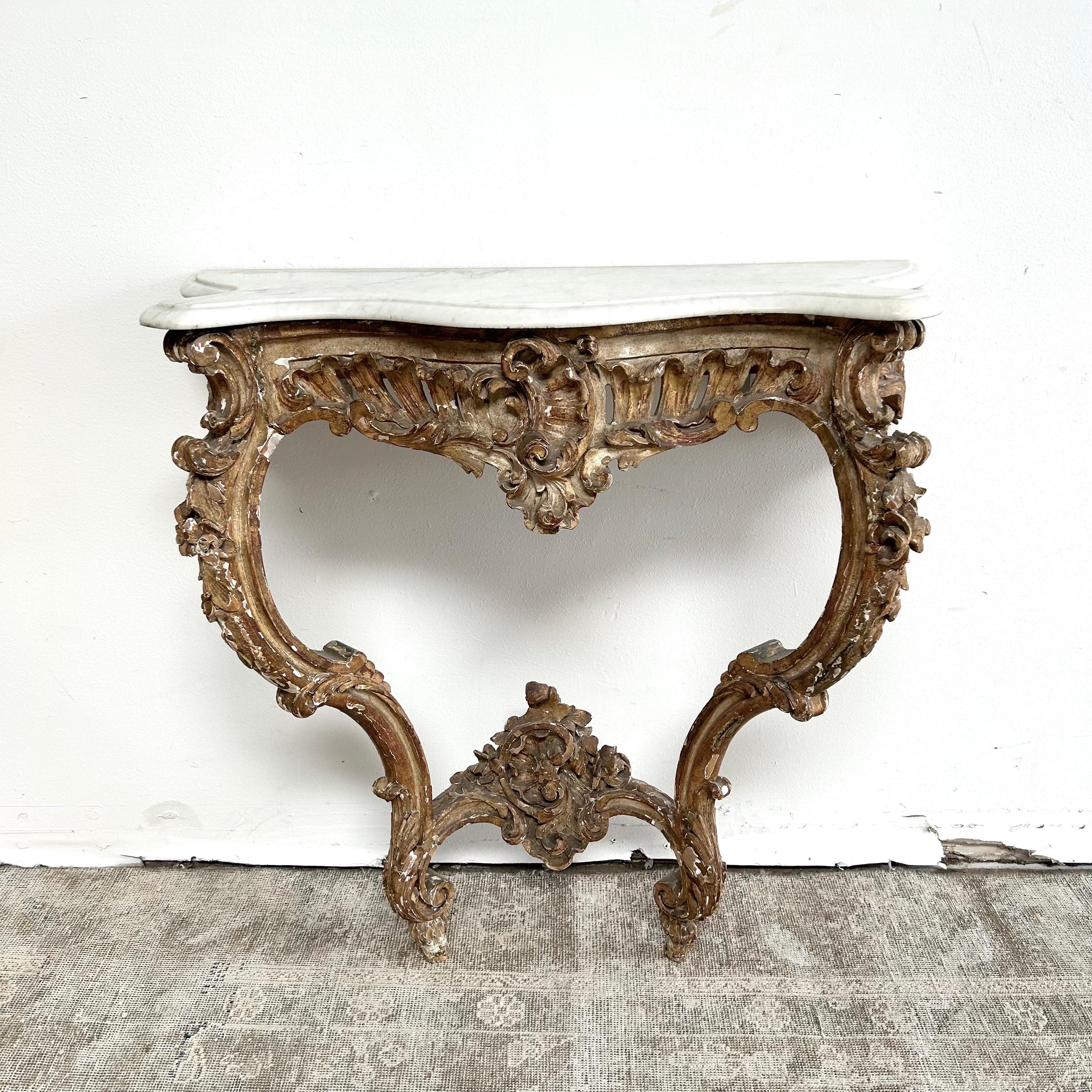 Antique wall console with marble top
Gilt wood, with heavy distressed patina.
This console is solid and sturdy, sold as is with repairs.
The table shows signs of repairs at seams, this has been done well, the base is solid and sturdy.
The marble
