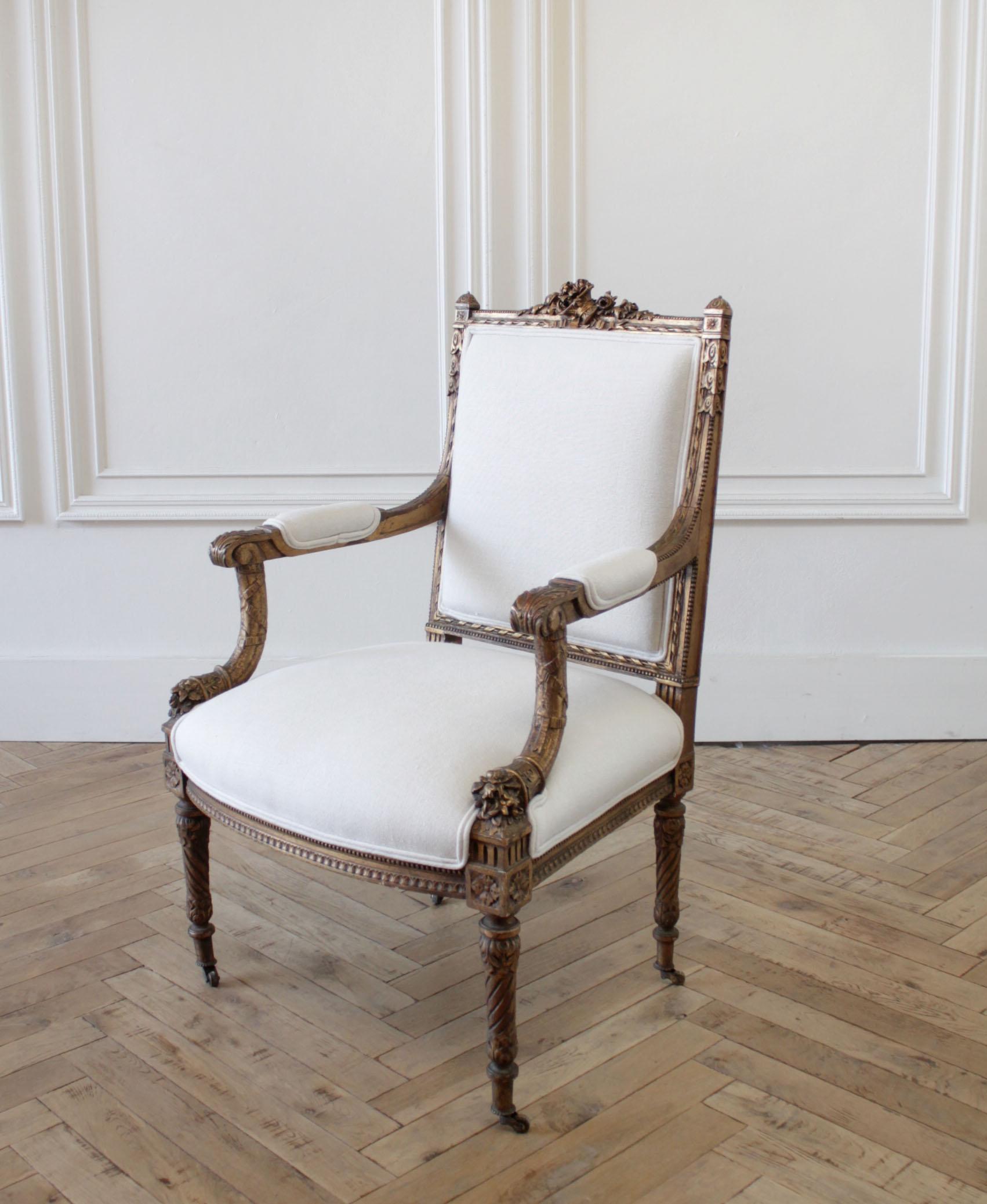 Antique giltwood French Louis XVI style chair with linen upholstery
Original giltwood finish, areas of finish are faded, or worn away. Beautiful carved roses adorn the top the chair, large carved floral cornucopias at the base of each arm. Note