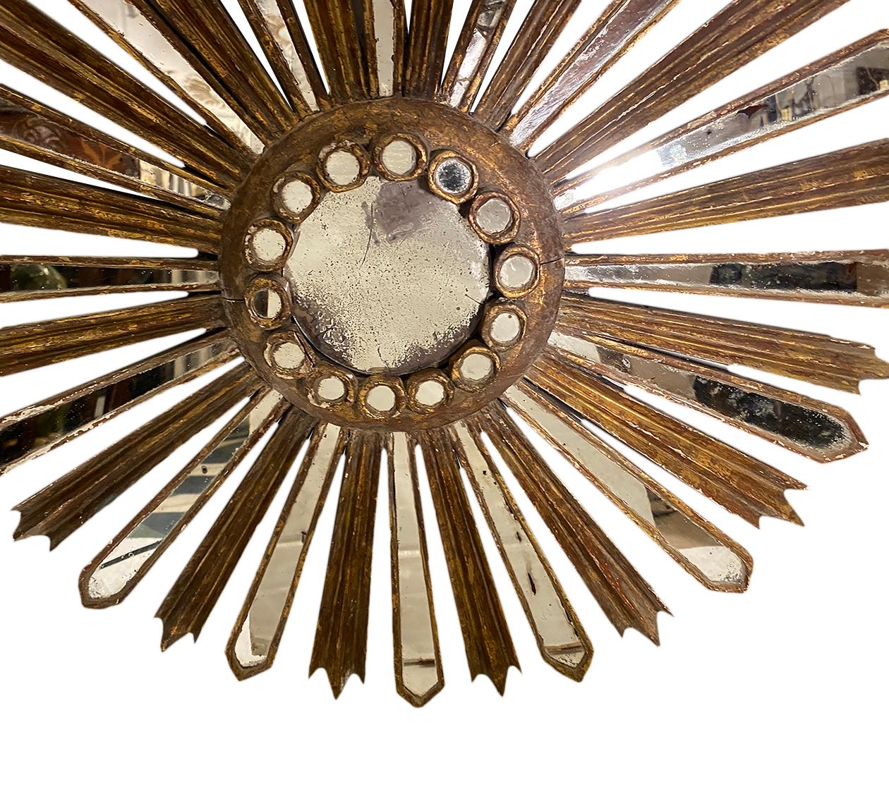 A circa 1920's Spanish gilt wood sunburst mirror.

Measurements:
Diameter: 21