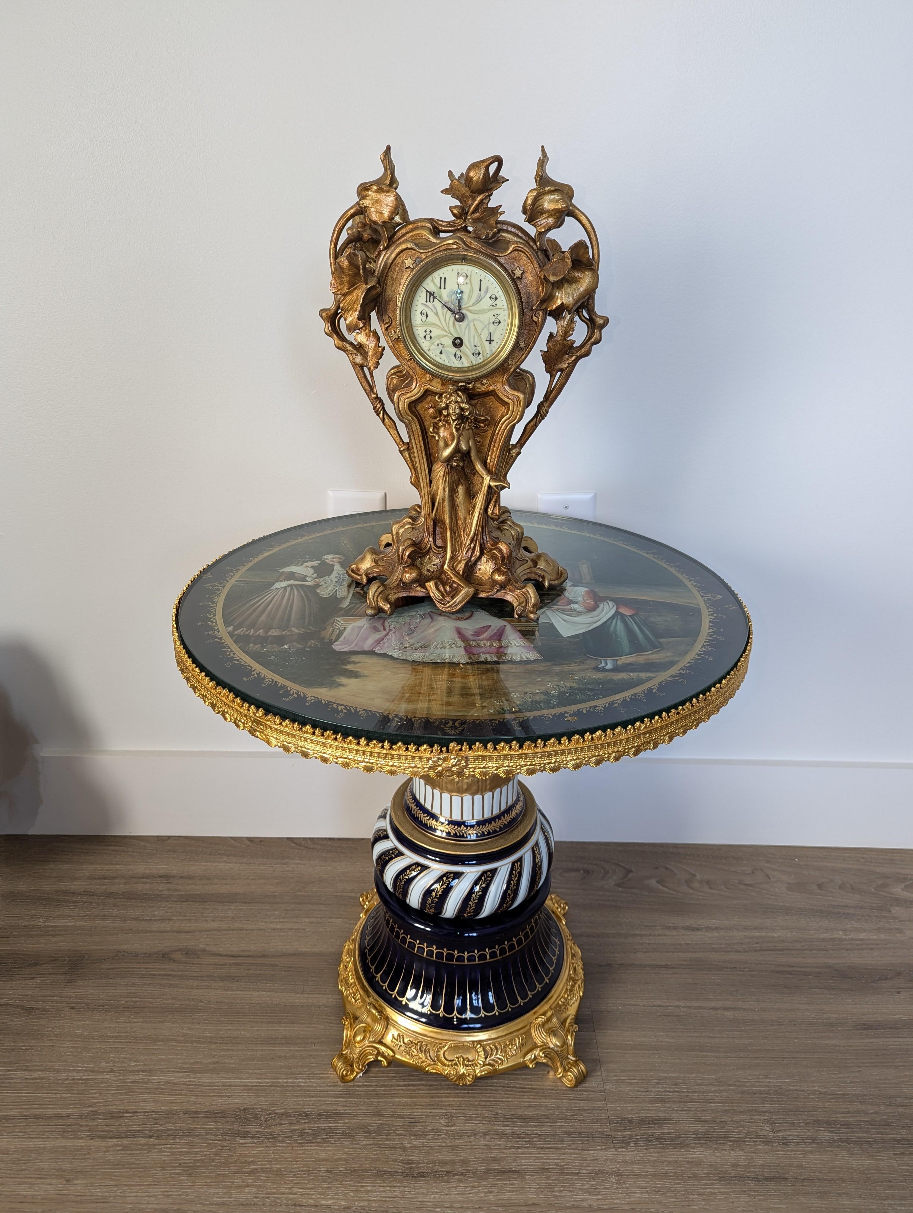 This antique gilted bronze Art Nouveau mantel clock is a stunning example of turn-of-the-century craftsmanship, embodying the flowing elegance and natural motifs that define the Art Nouveau movement. Standing at 16 inches tall, this clock combines