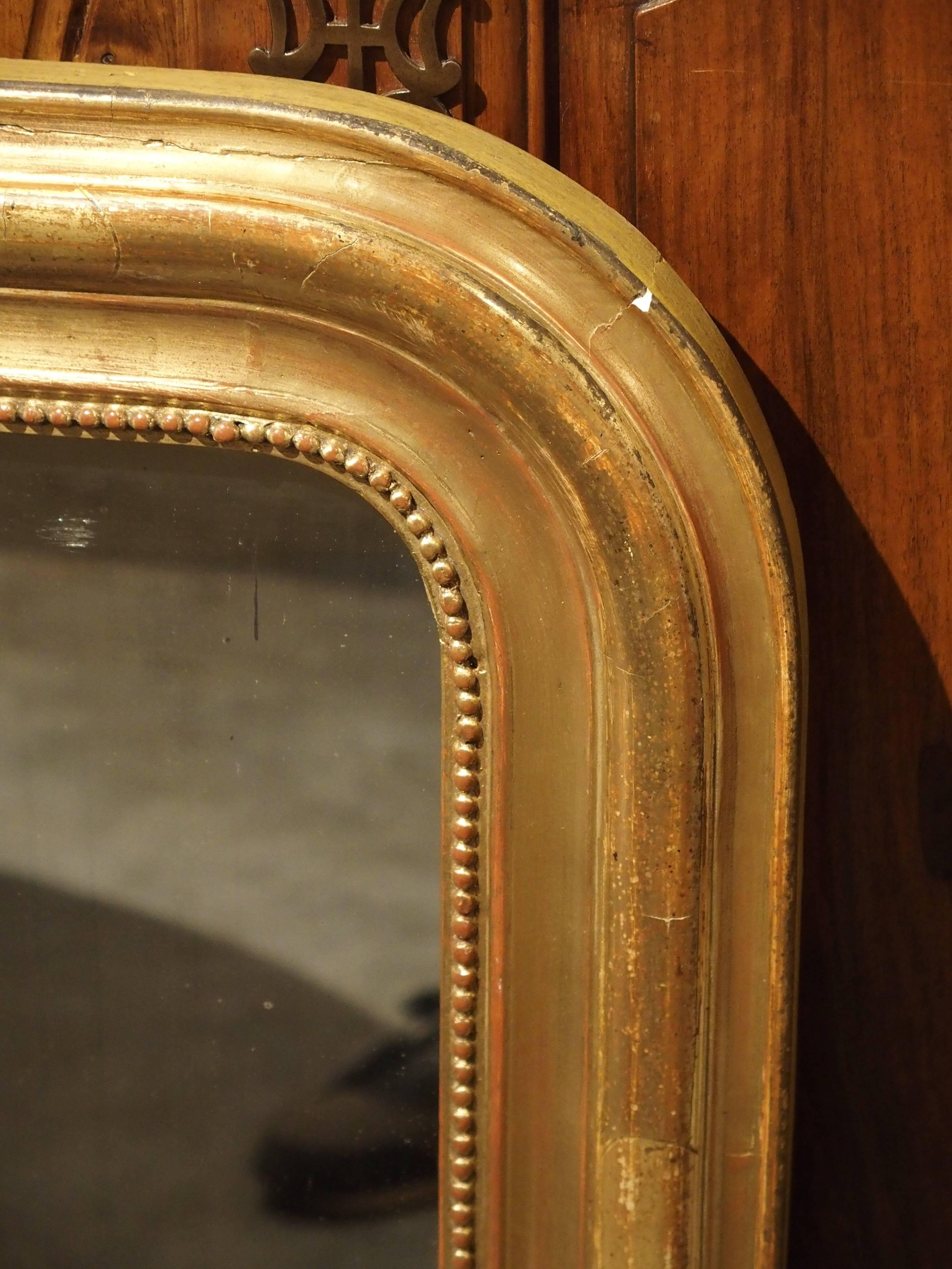 This versatile, clean lined, antique French Louis Philippe mirror is over 100 years old and can be used with almost any style of furnishing. Louis Philippe mirrors were made from the middle of the 1800s through the last half of the 19th century. On