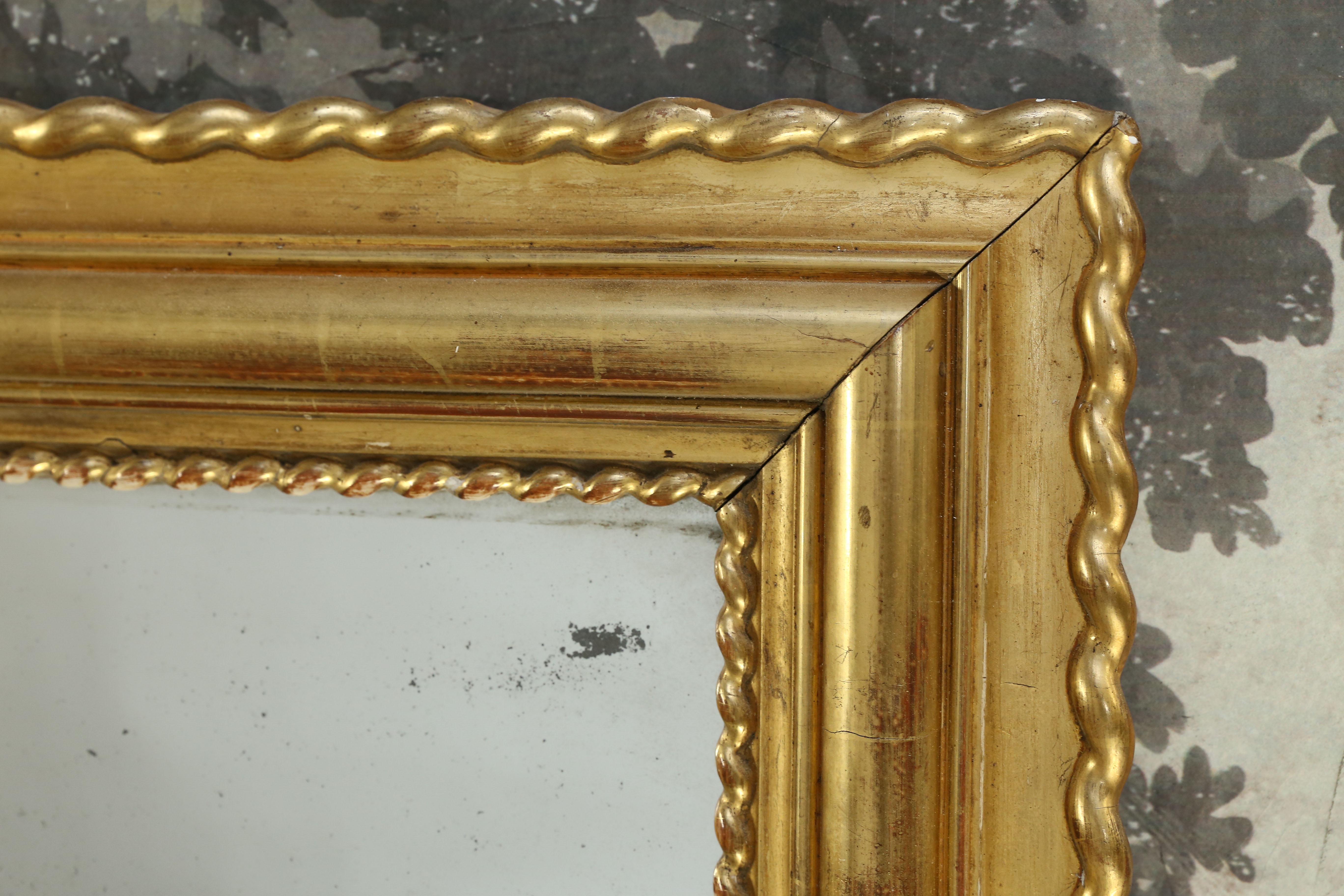 Large rectangular Giltwood Louis Philippe Mirror from France with gilded rope trim.