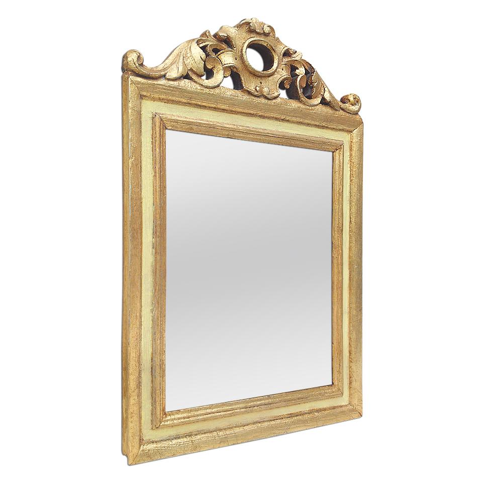 Antique giltwood mirror, French Provincial style inspiration, circa 1935. Carved giltwood pediment adorned with foliages stylised. Antique frame gilding to the leaf and patinated yellows colors. Modern glass mirror. Antique wood back.