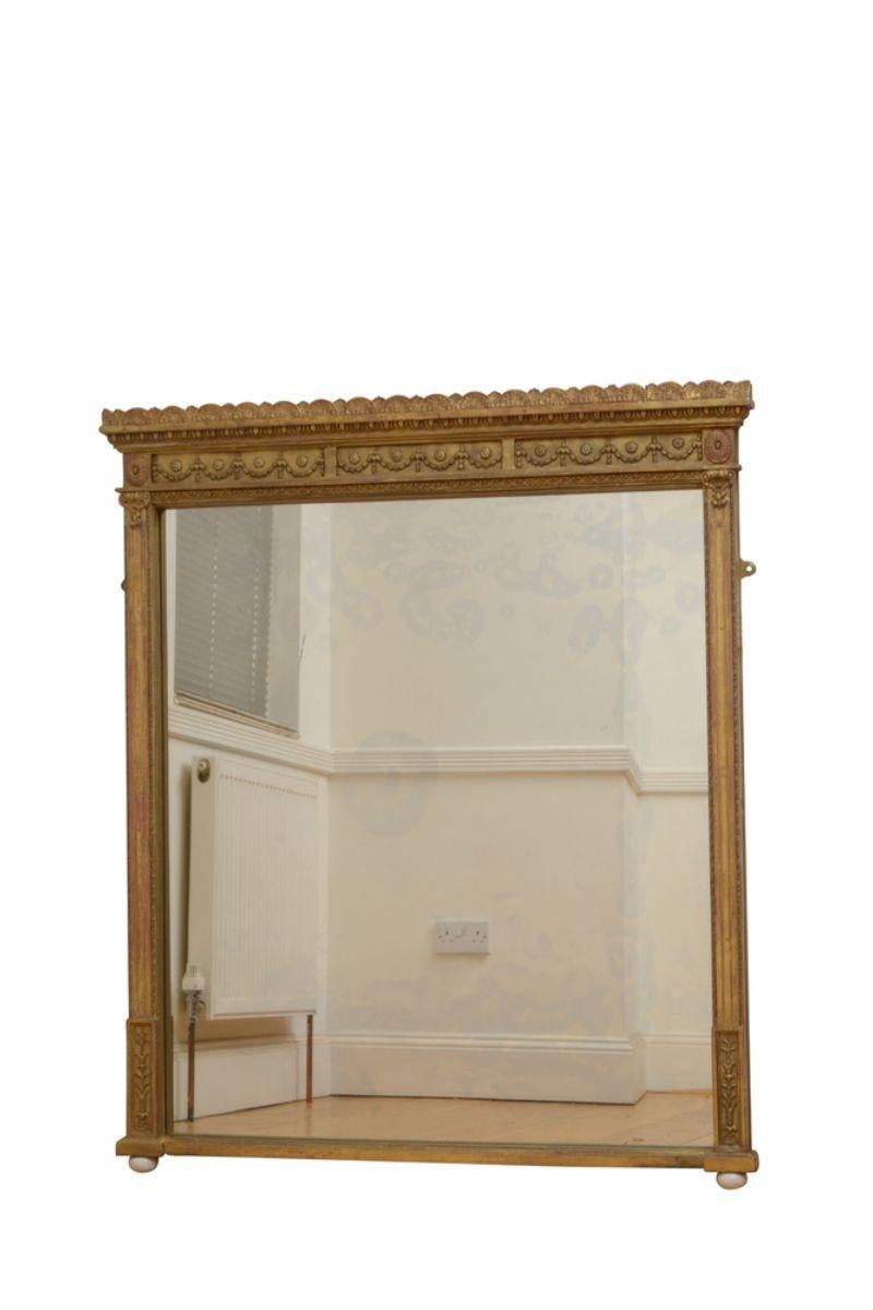 K0603 Elegant 19th century gilded wall mirror having original glass with some foxing and minor imperfections in gilded frame decorated with rope carving to inner and outer edge, reeded columns with flower carved capitols and harebell frieze below