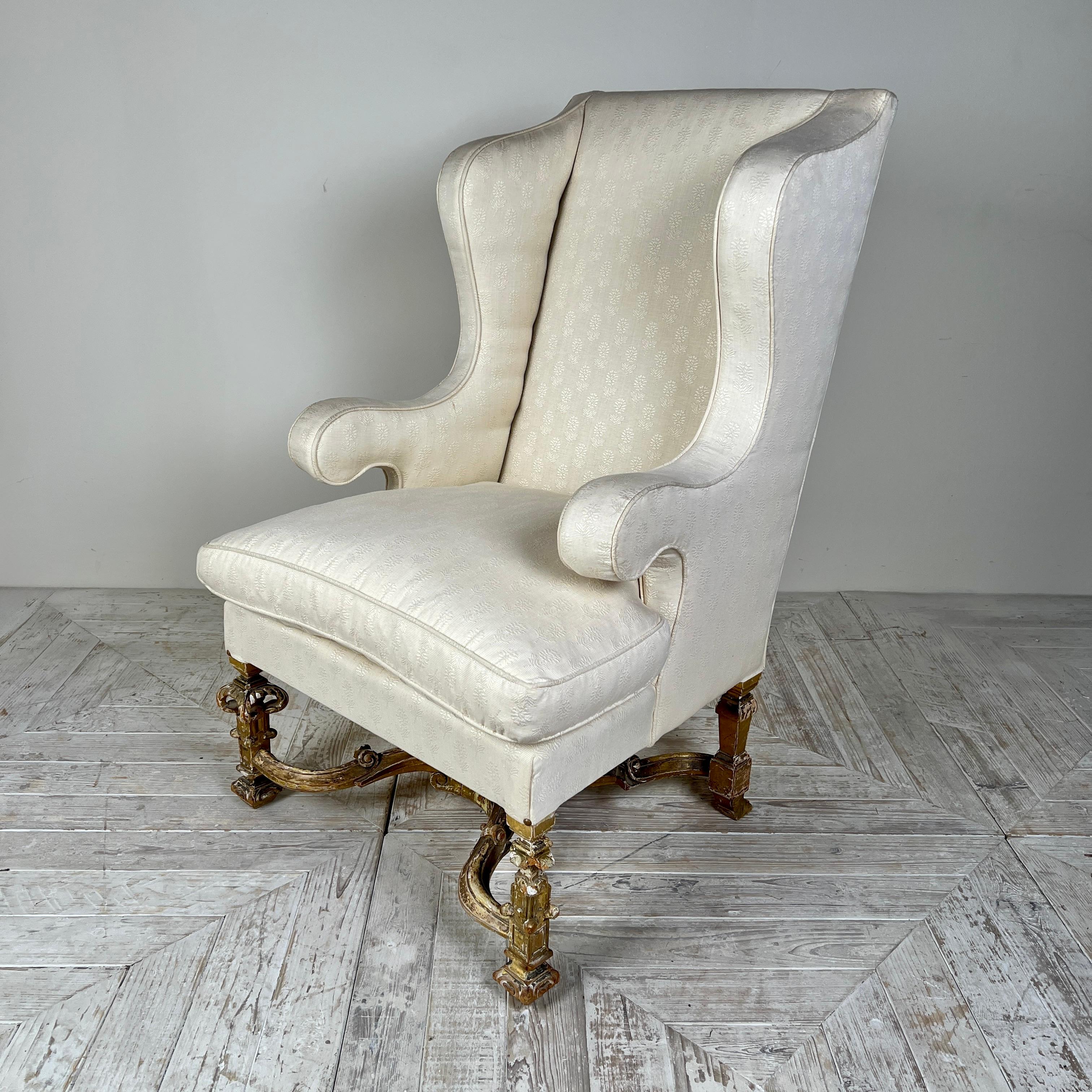 A Beautiful and Curvaceous Antique Giltwood Wingback Armchair in the Late 17th Century Style

This elegant armchair is upholstered in a soft cream fabric and features a generously filled feather cushion for added comfort.

The gracefully scrolled