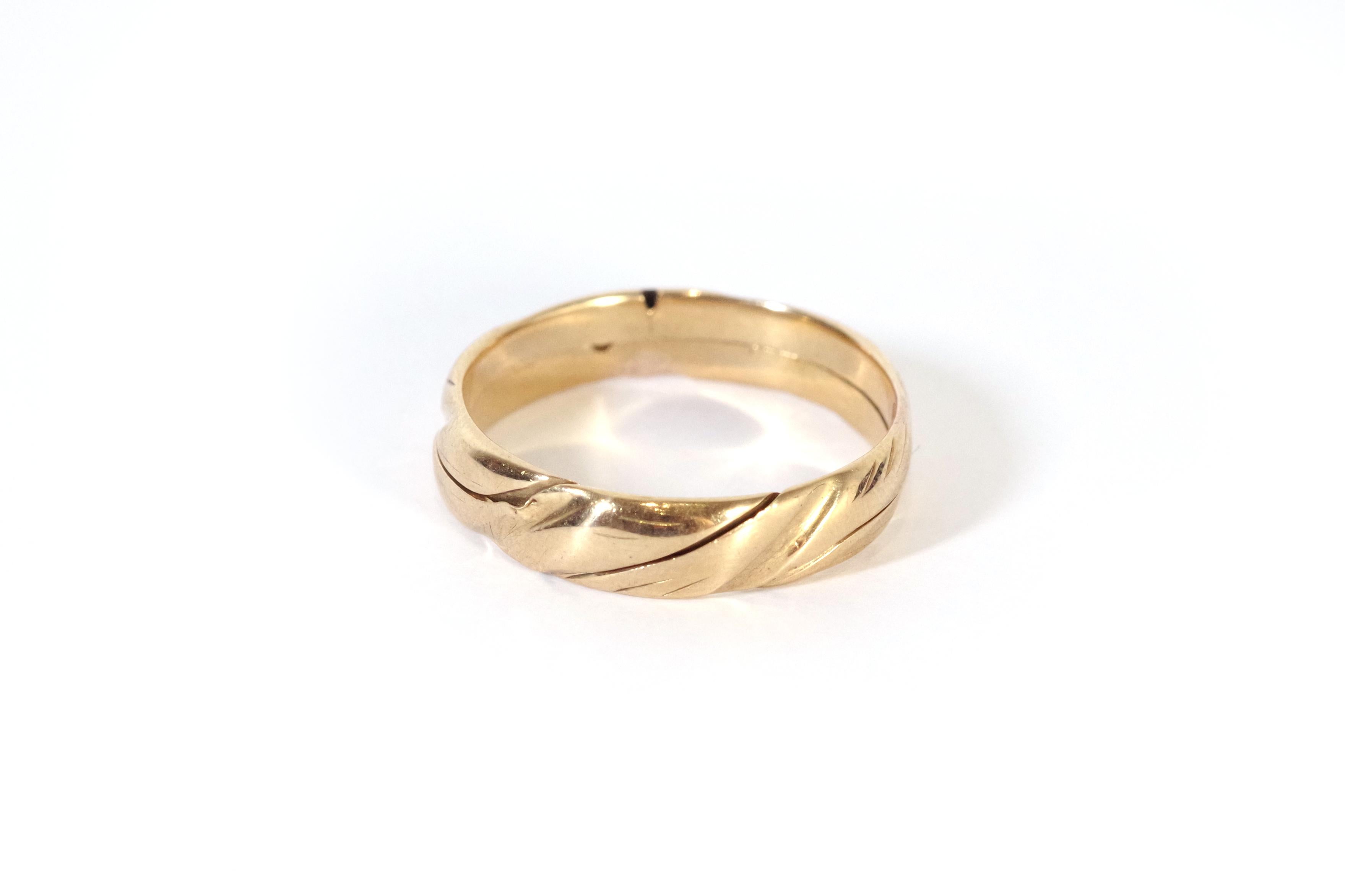 Antique gimmel ring in 18 karat rose gold. This antique puzzle ring set features two interlocking rings crafted from 18-karat rose gold. The rings form a complete round hoop when interlocked and create a delightful puzzle-like design. While these