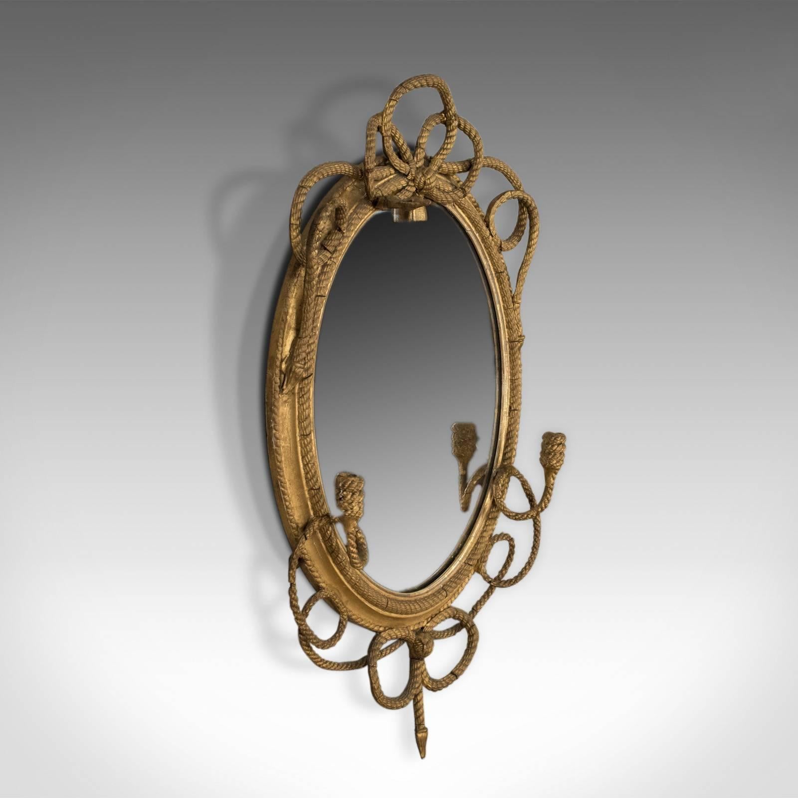 This is an antique girandole wall mirror, an early 19th century, late Georgian, gilt gesso frame with nautical overtones dating to circa 1820.

Attractive mid-sized Georgian wall mirror
Gilt gesso displaying desirable aged patina
Rope twist