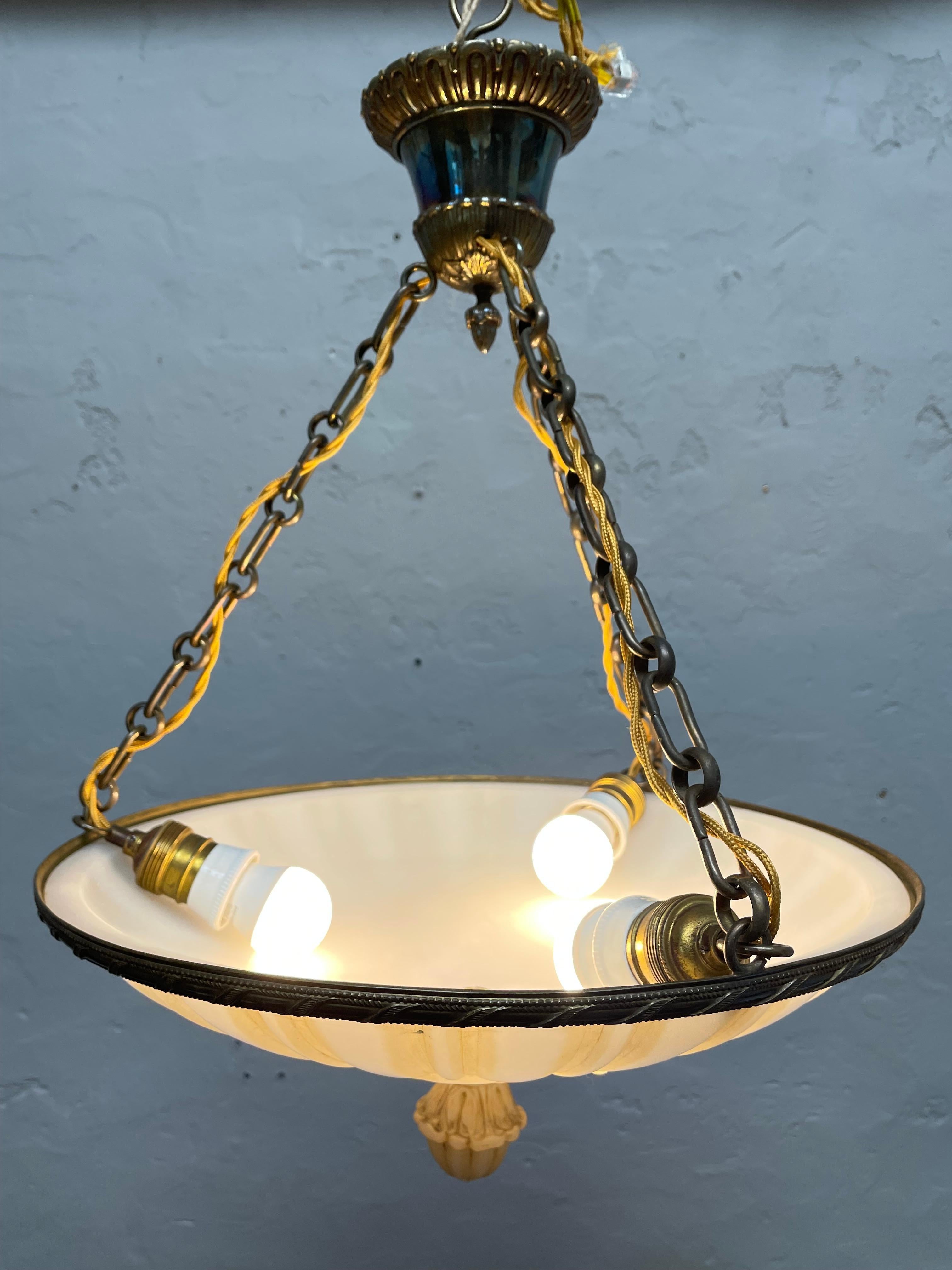 Antique glass alabaster plafonnier chandelier in great condition and with age related wear.
Decorated brass ceiling cup with a brass finial on the bottom. 
Brass hanging chains. 
Brass shade holder. 
Lovely age related patina to all the brass.