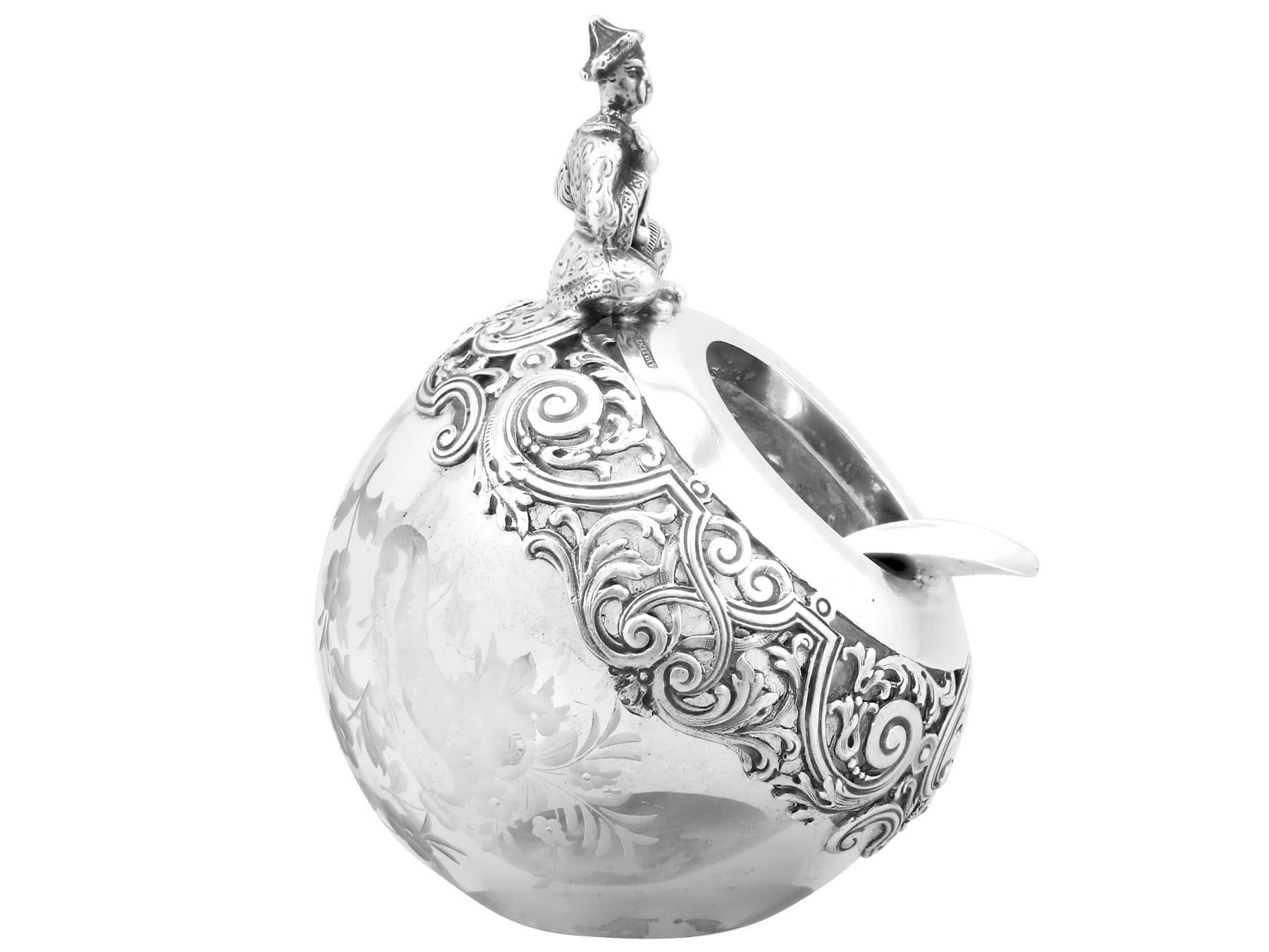 An exceptional, fine and impressive antique Spanish 916 standard silver and glass ashtray an addition to our ornamental collection.

This exceptional antique glass ashtray has a globular form.

The surface of the glass body is embellished with