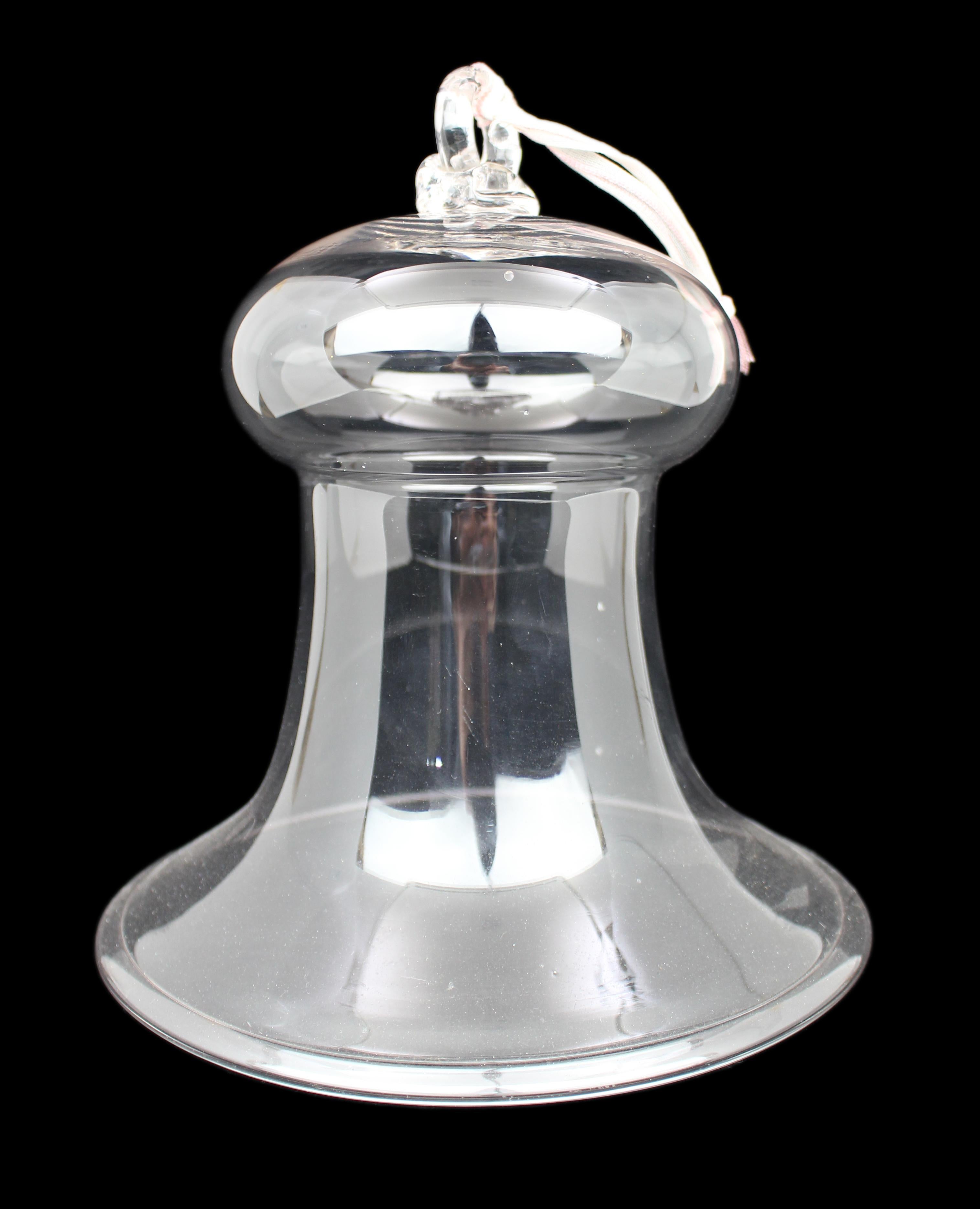 Antique Glass Bell Form Smoke Cover, c.1900

A good quality antique clear glass smoke cover of bell form, dating to the late 19th or early 20th century. Hand-blown with a well-shaped loop handle to the top and original hanging cord. Made to be hung