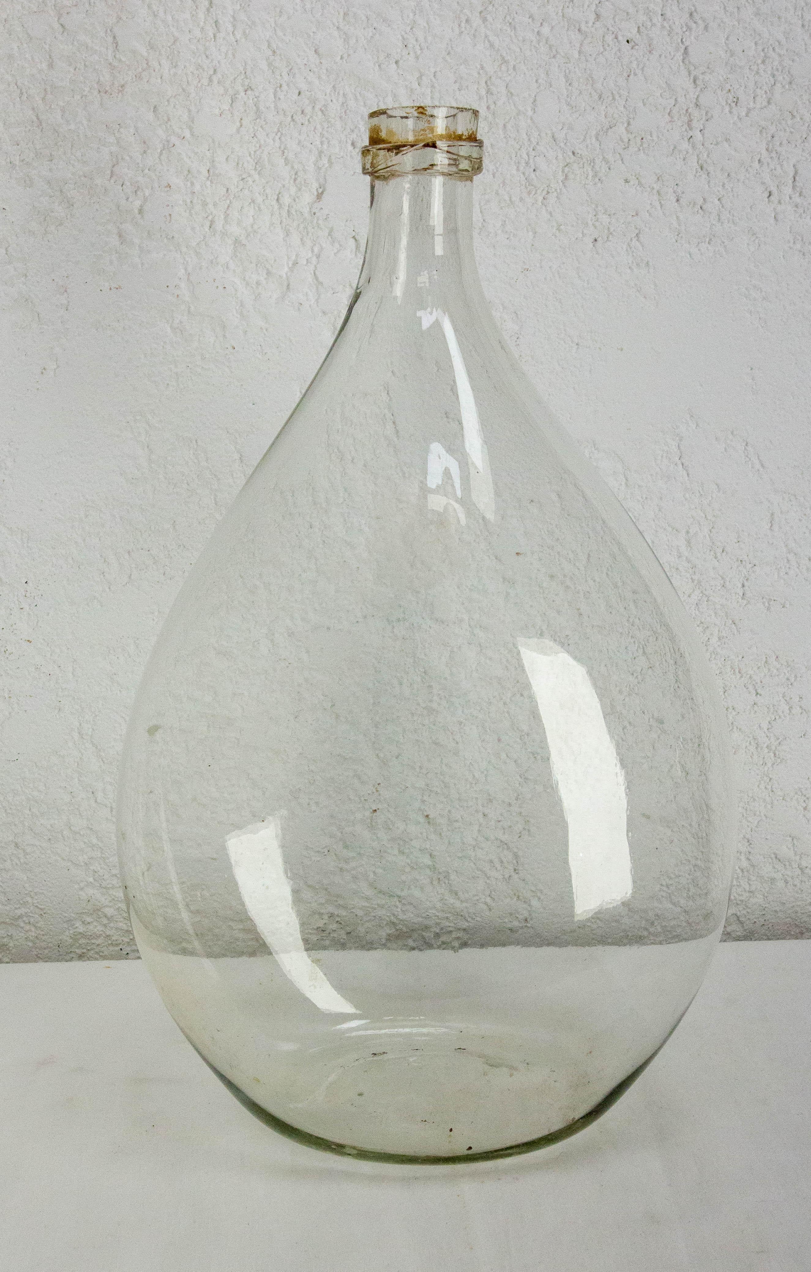 Dame Jeanne or carboy antique glass bottle demijohn
Irregularities in the glass that give it all its charm: the the bottle is mouth-blown by a glassmaker.
The unique shape of this carboy makes it stand out from the crowd.

Good condition with marks