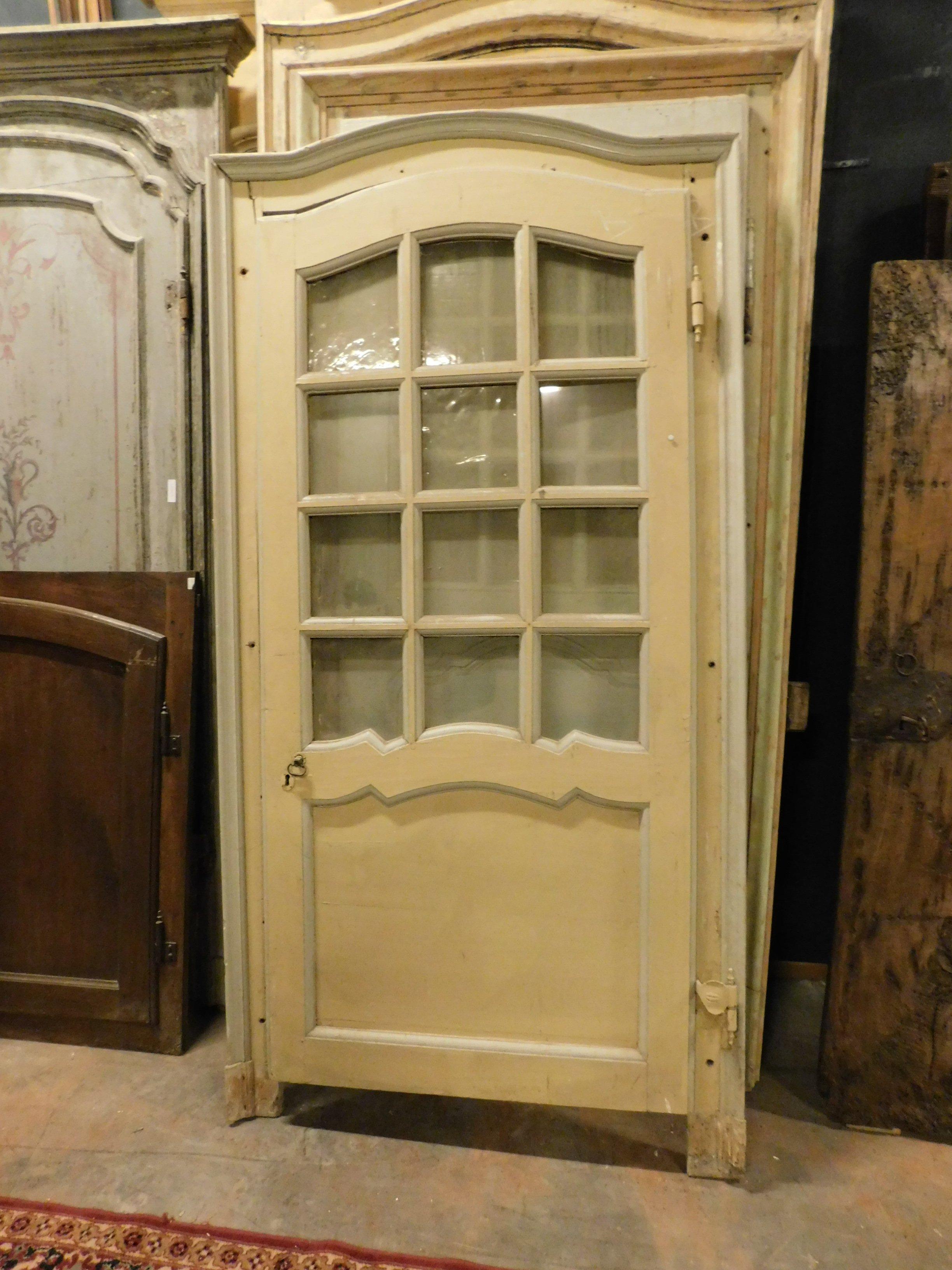 Antique wooden glass door, with panel and wavy frame typical of the time, pale yellow or light gray lacquer, with original gooseneck (crooked opening), original irons and handle, still with its glass, built entirely by hand in the late 1700s by