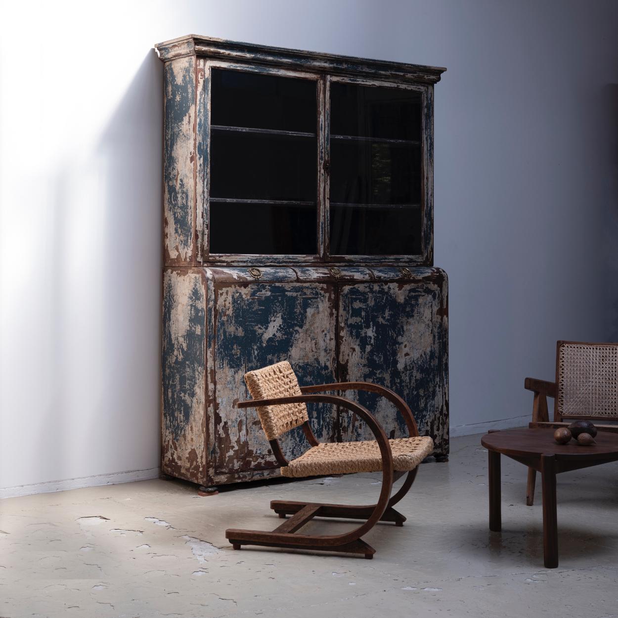 Antique huge cabinet from Spain. Early 19th century. Excellent patina that can be seen from the age of the layers of paint.
Three drawers with decorative brass handles in the middle. The double-hinged glass front doors on the upper and the wooden