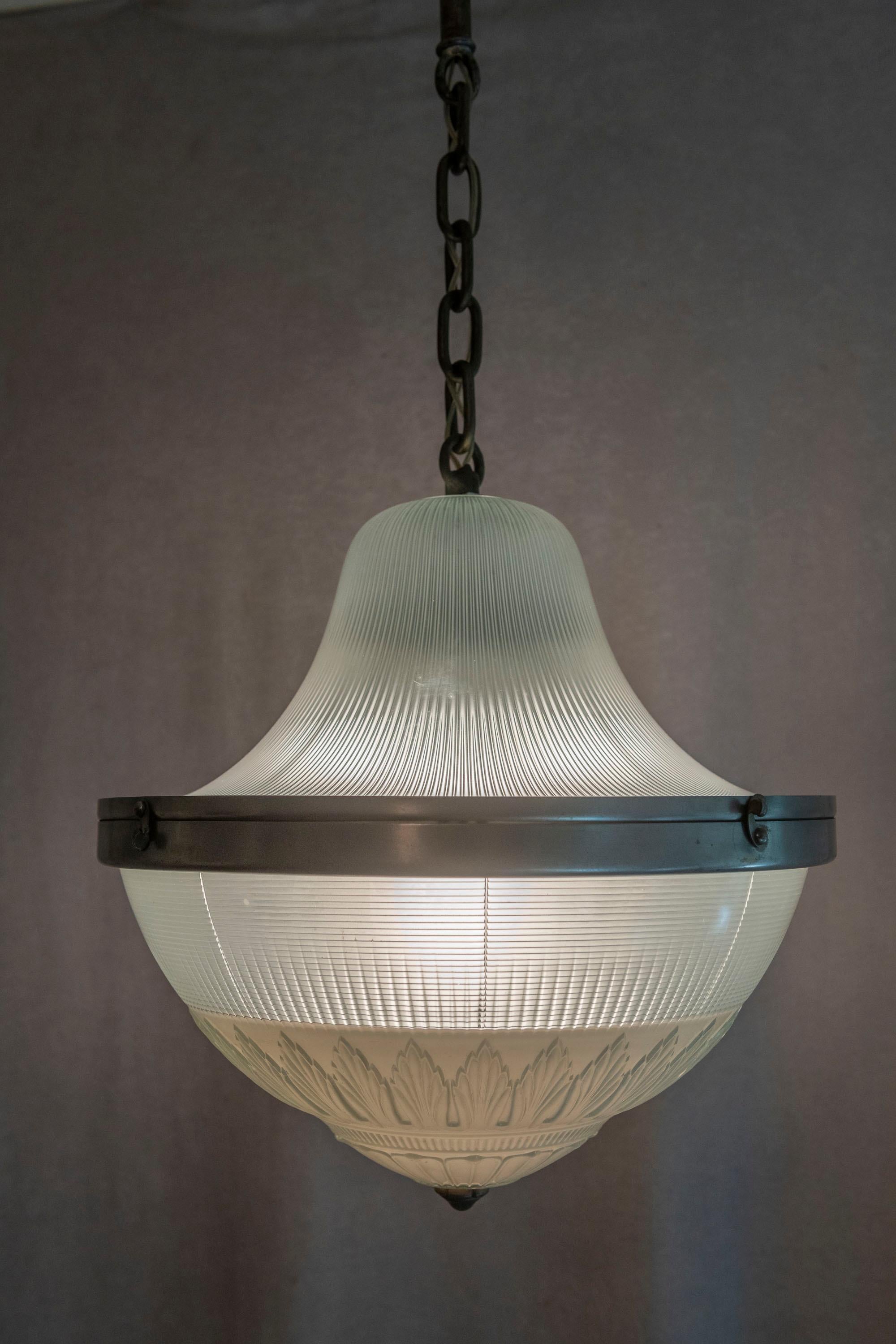  This pendant is timeless. It looks modern at first until you study the glass and the workmanship. While unsigned it certainly looks like the work of the Holophane Glass Co. They opened their first company in the U.S. in New York in 1896. For a more