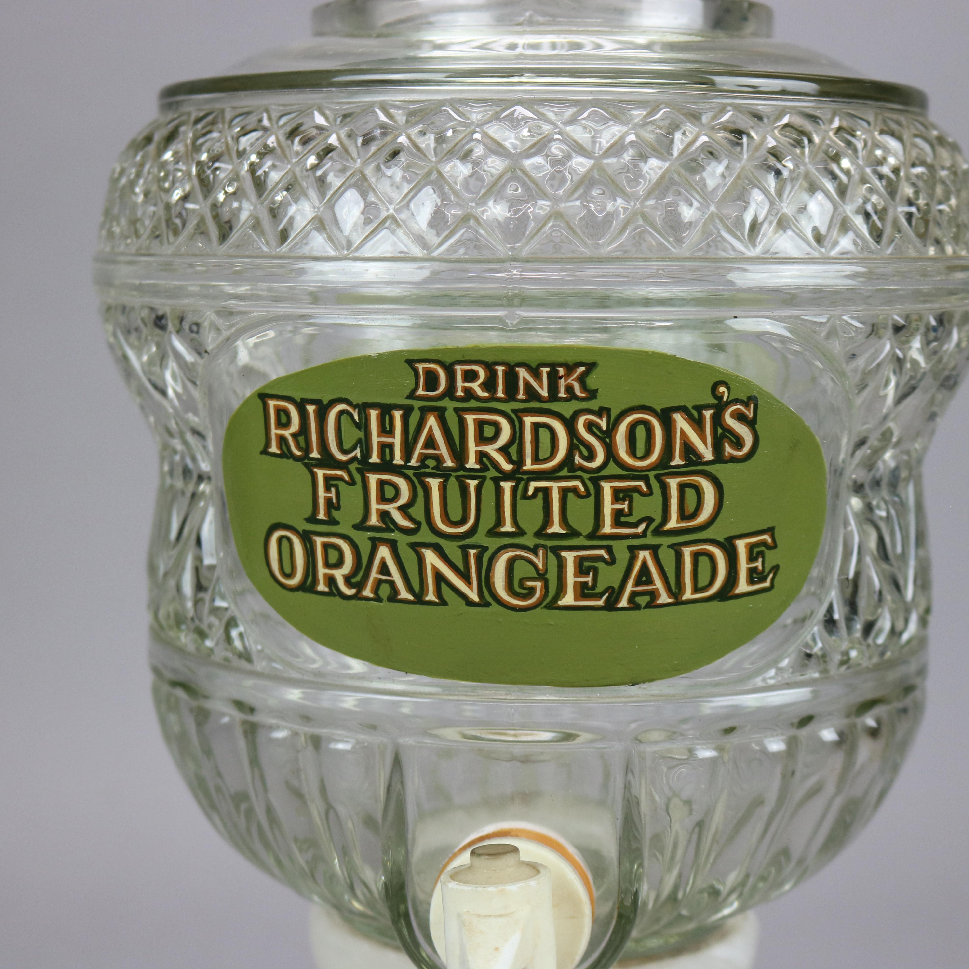 An antique Richardson’s Fruit Orangeade advertising table or counter top juice dispenser offers pressed glass vessel with lid, painted and gilt advertising reserve, spout and raised on flared pedestal, c1900

Measures - 16.75'' H x 7.5'' W x 10''