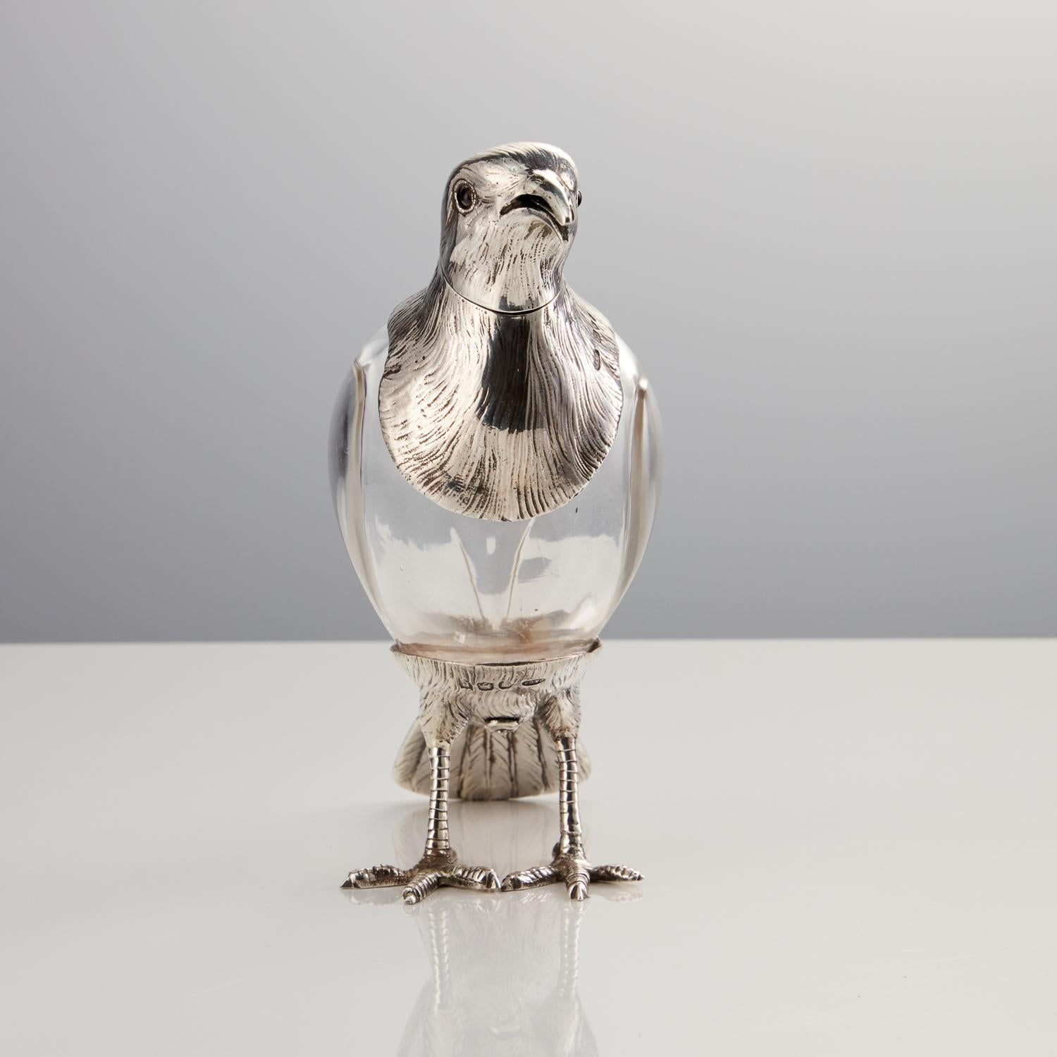 A rare antique glass & sterling silver bird decanter for dispensing angostura bitters by Asprey London 1892.

This rare antique glass and sterling silver bird decanter is excellent condition and has been beautifully crafted. The item is fully