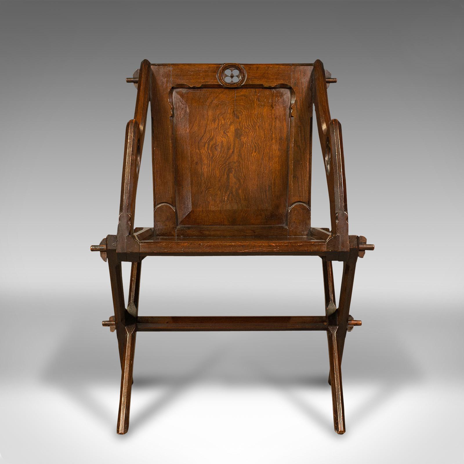 This is an antique Glastonbury chair. An English, pitch pine decorative armchair with Gothic overtones, dating to the Victorian period, circa 1880.

Delightful example of the fabled Glastonbury chair, with superb form and detail
Displaying a