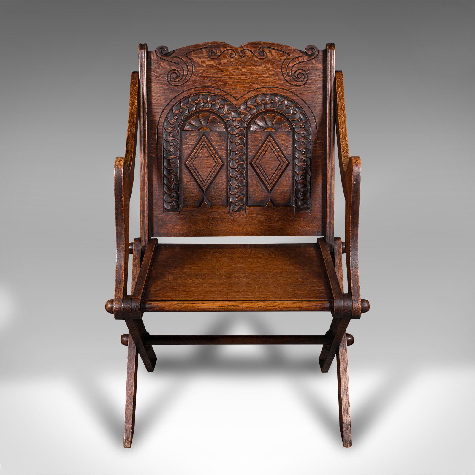 
This is an antique Glastonbury chair. A Welsh, oak ecclesiastical elbow seat with Gothic overtones, dating to the late Victorian period, circa 1880.

A classic provincial example of the striking Glastonbury chair
Displays a desirable aged patina
