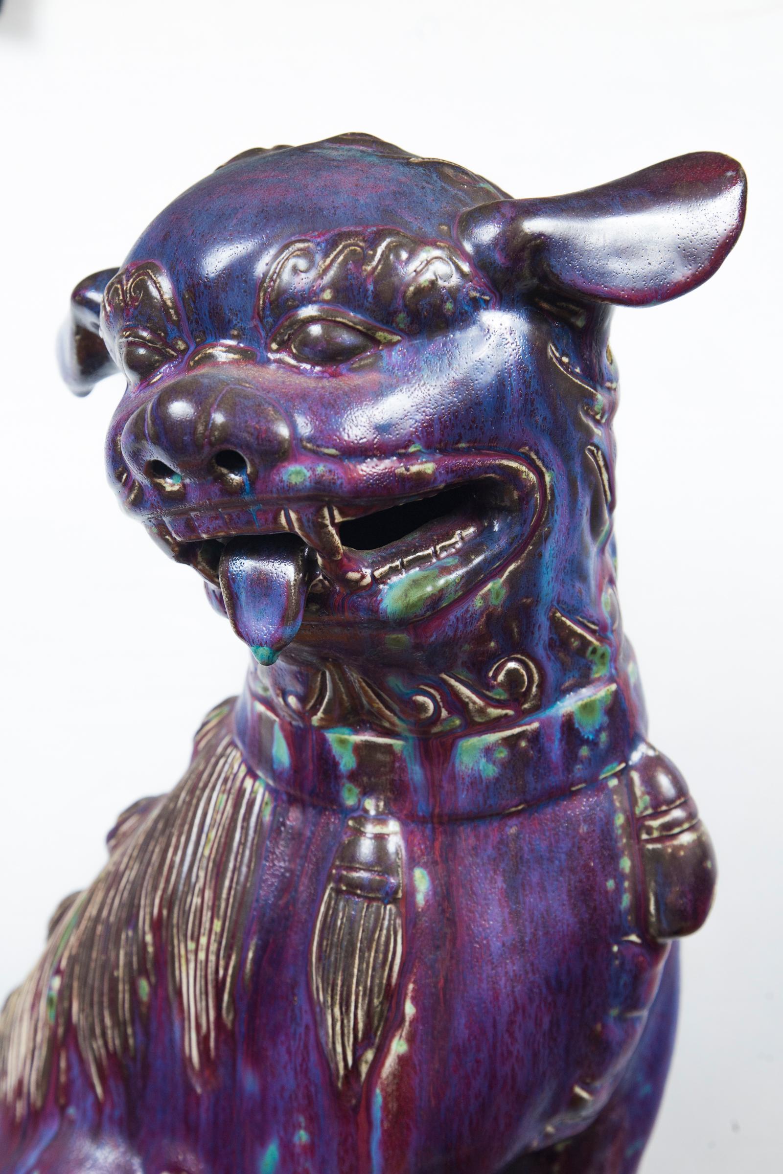This is a female foo dog, as shown with her baby under her front right paw. Deep flambe glaze over pottery. Raised on a pierced rectangular pedestal.
The pedestal measures 8 tall, 10 .5 wide and 6.75 deep. The figure thus is 19 inches tall.