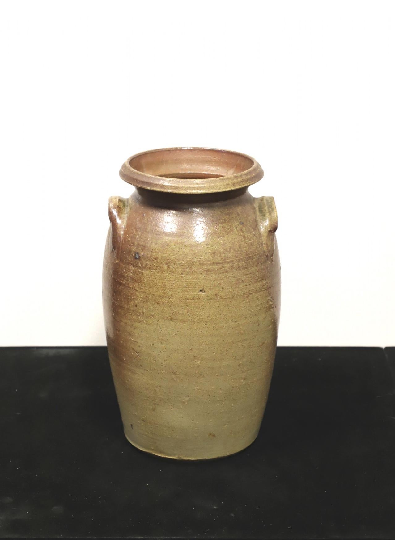 An antique 19th Century early American glazed pottery urn with handles. Unsigned, artist unknown. Ceramic pottery with a glazed finish. The number 