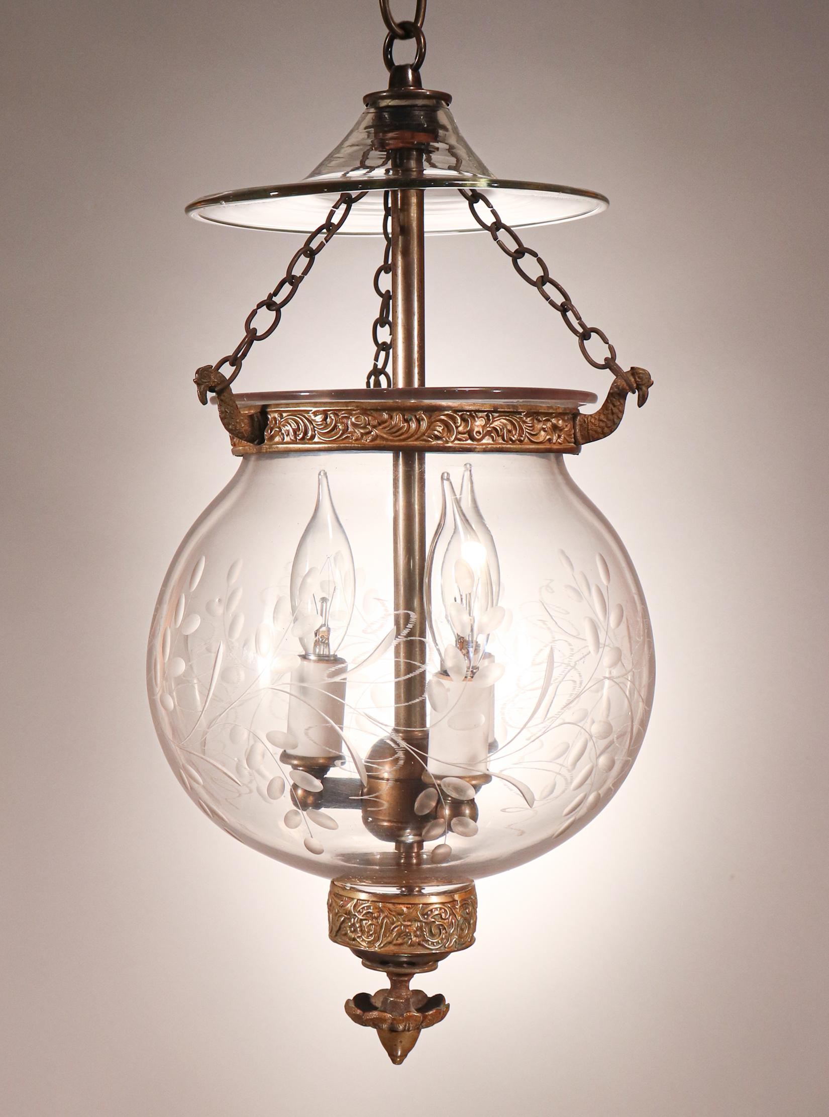An exceptional bell jar lantern in our collection, this circa 1860 English globe pendant has lovely form and features all-original brass fittings—including its embossed brass band, ornamental finial/candle holder base, and strands of chain. The