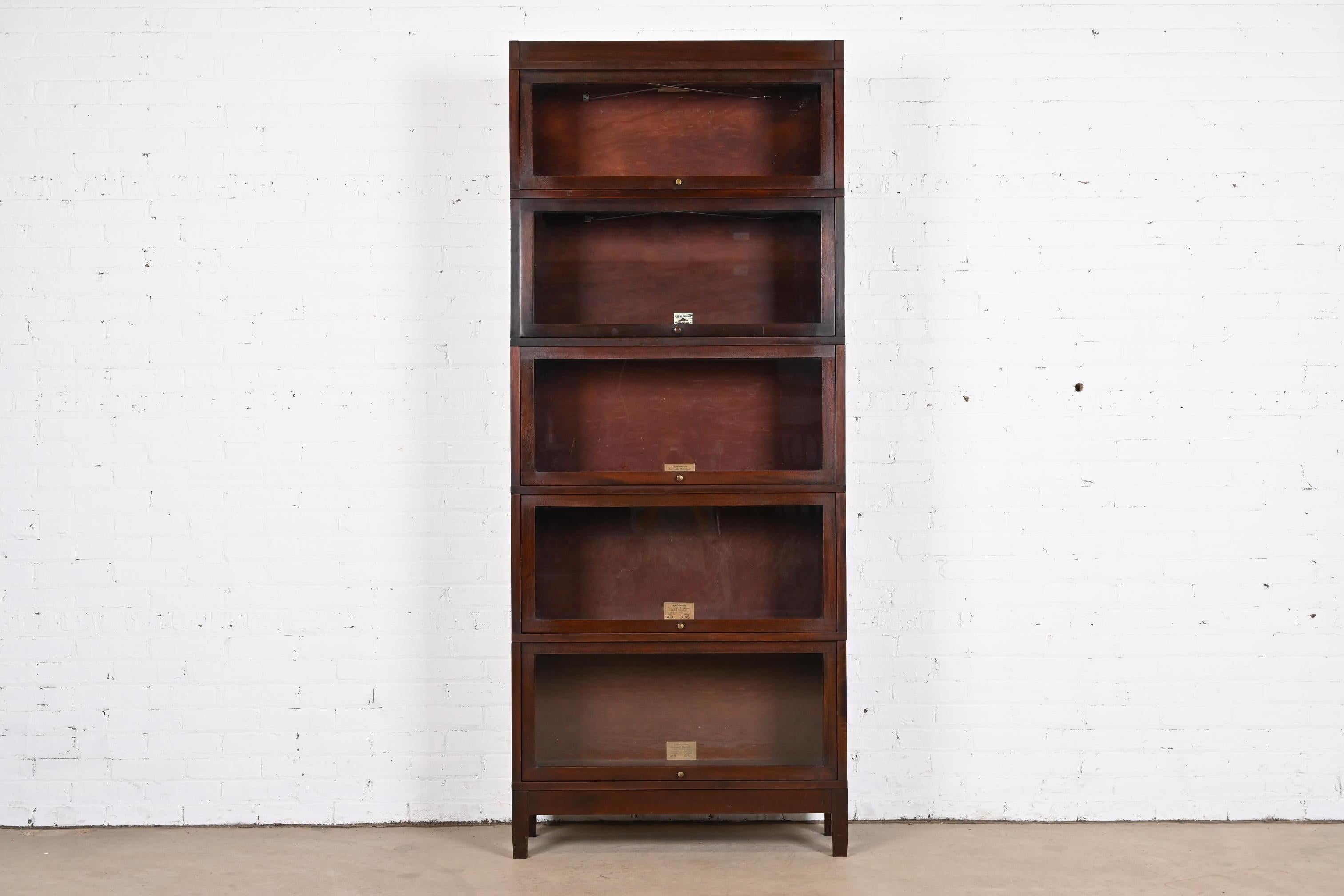A gorgeous antique Arts & Crafts five-stack barrister bookcase

By Globe Wernicke

USA, Circa 1890s

Mahogany, with glass front doors and brass hardware.

Measures: 34.38