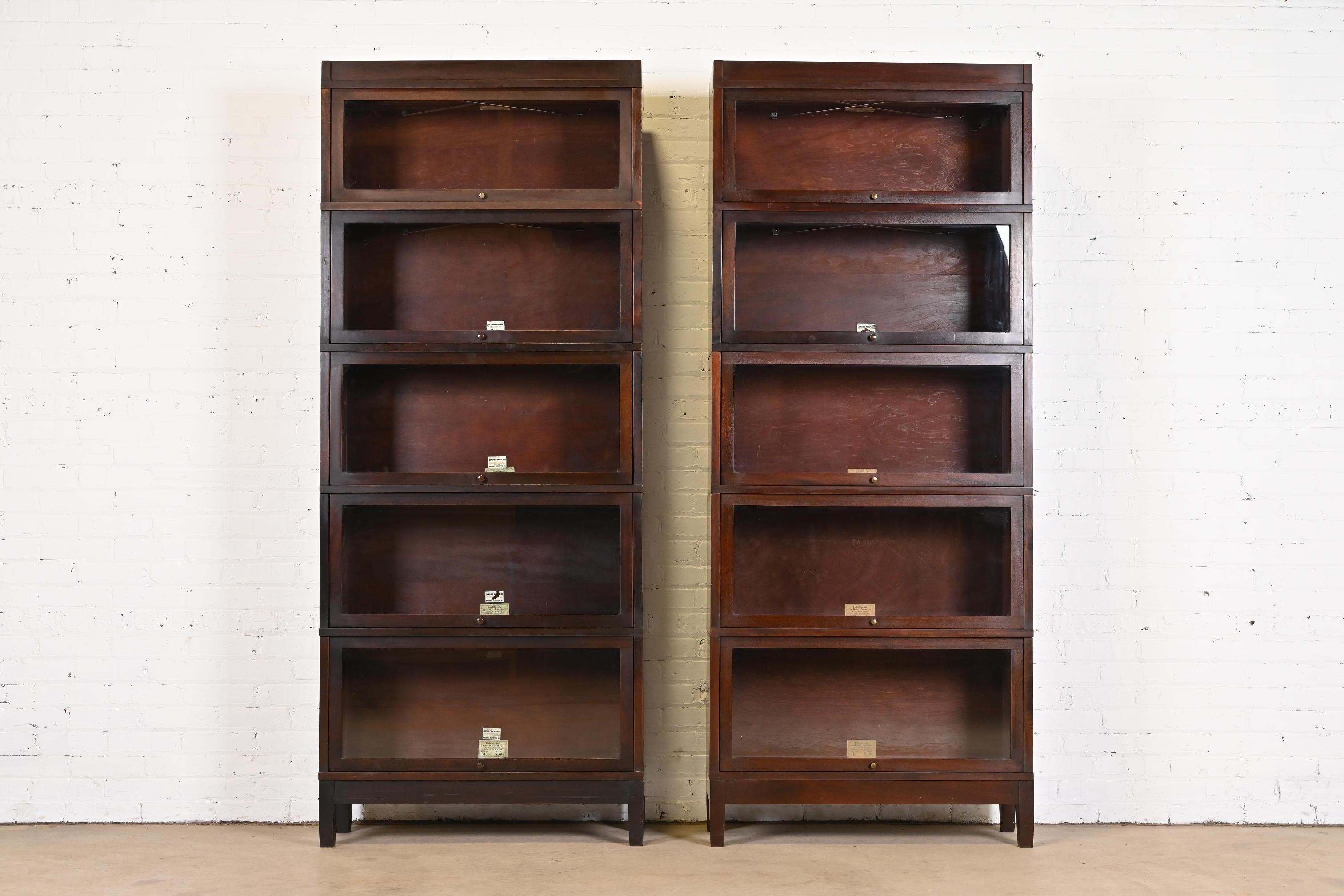 A gorgeous pair of antique Arts & Crafts five-stack barrister bookcases

By Globe Wernicke

USA, Circa 1890s

Mahogany, with glass front doors and brass hardware.

Measures: 34.38