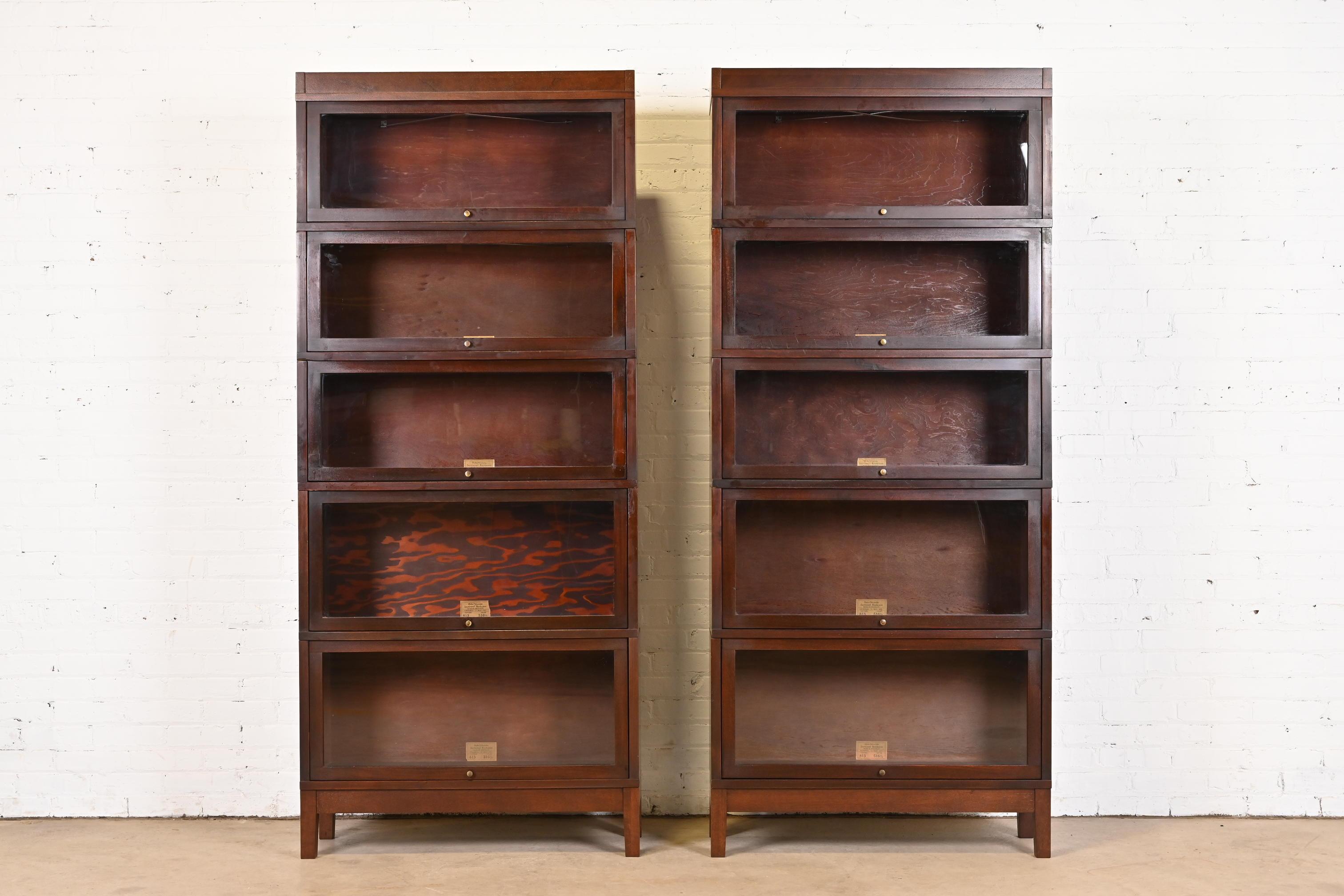 A gorgeous pair of antique Arts & Crafts five-stack barrister bookcases

By Globe Wernicke

USA, Late 19th Century

Mahogany, with glass front doors and brass hardware.

Measures: 34.5