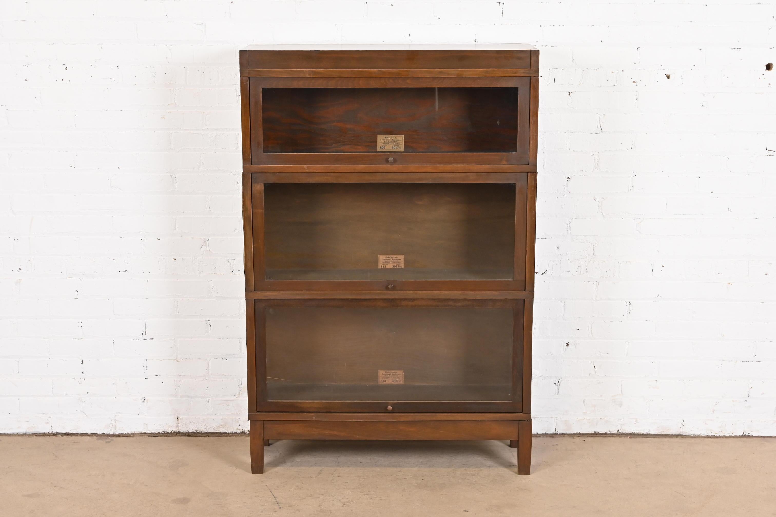 A gorgeous antique Arts & Crafts three-stack barrister bookcase

By Globe Wernicke

USA, Late 19th Century

Walnut, with glass front doors and brass hardware.

Measures: 34.25