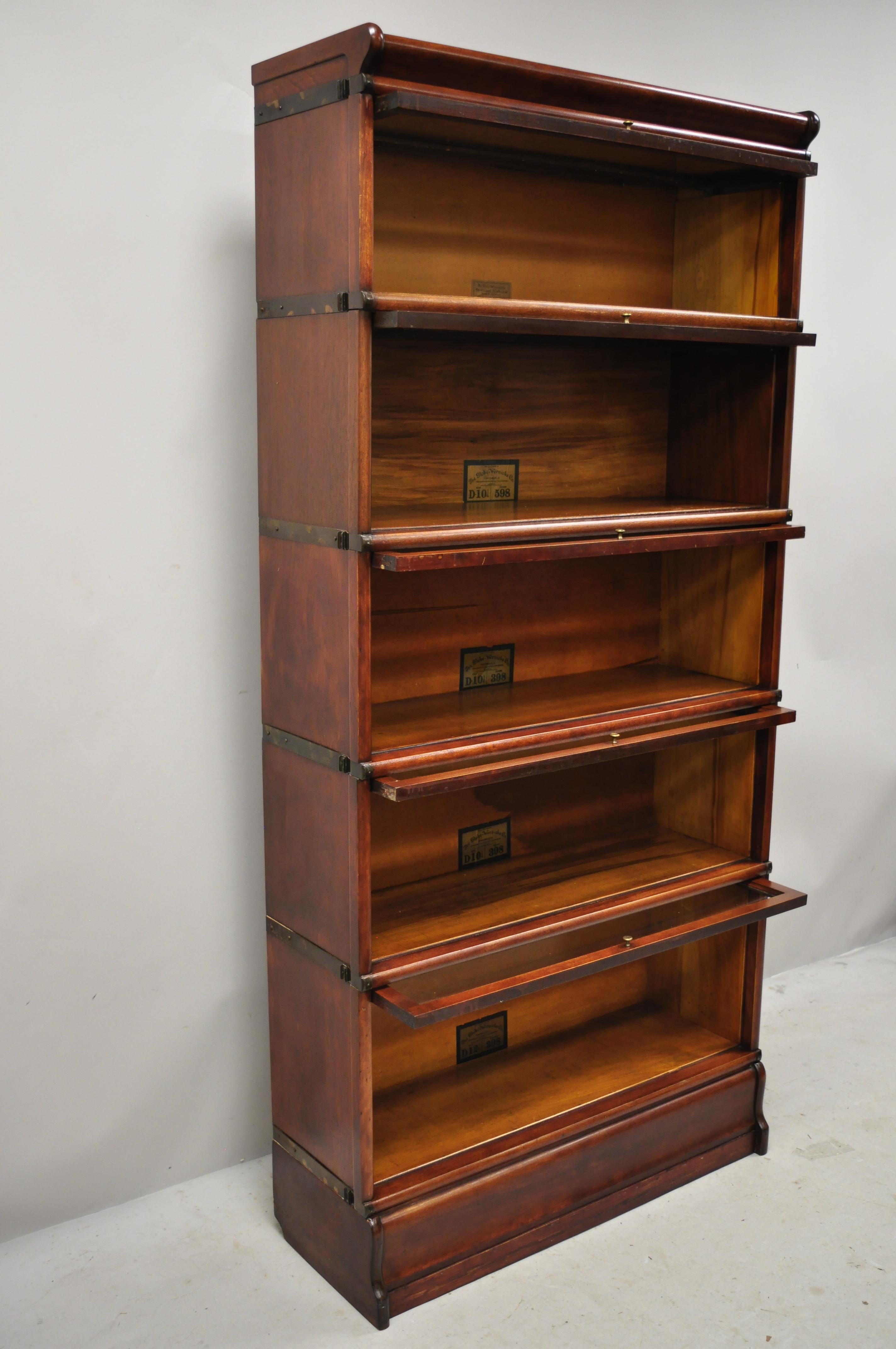 Antique Globe Wernicke mahogany 5-section stacking lawyers Barrister bookcase. Item features (5) sections, top base, original labels, a few sizes, metal bands to sides, circa early 20th century. Measurements: 71