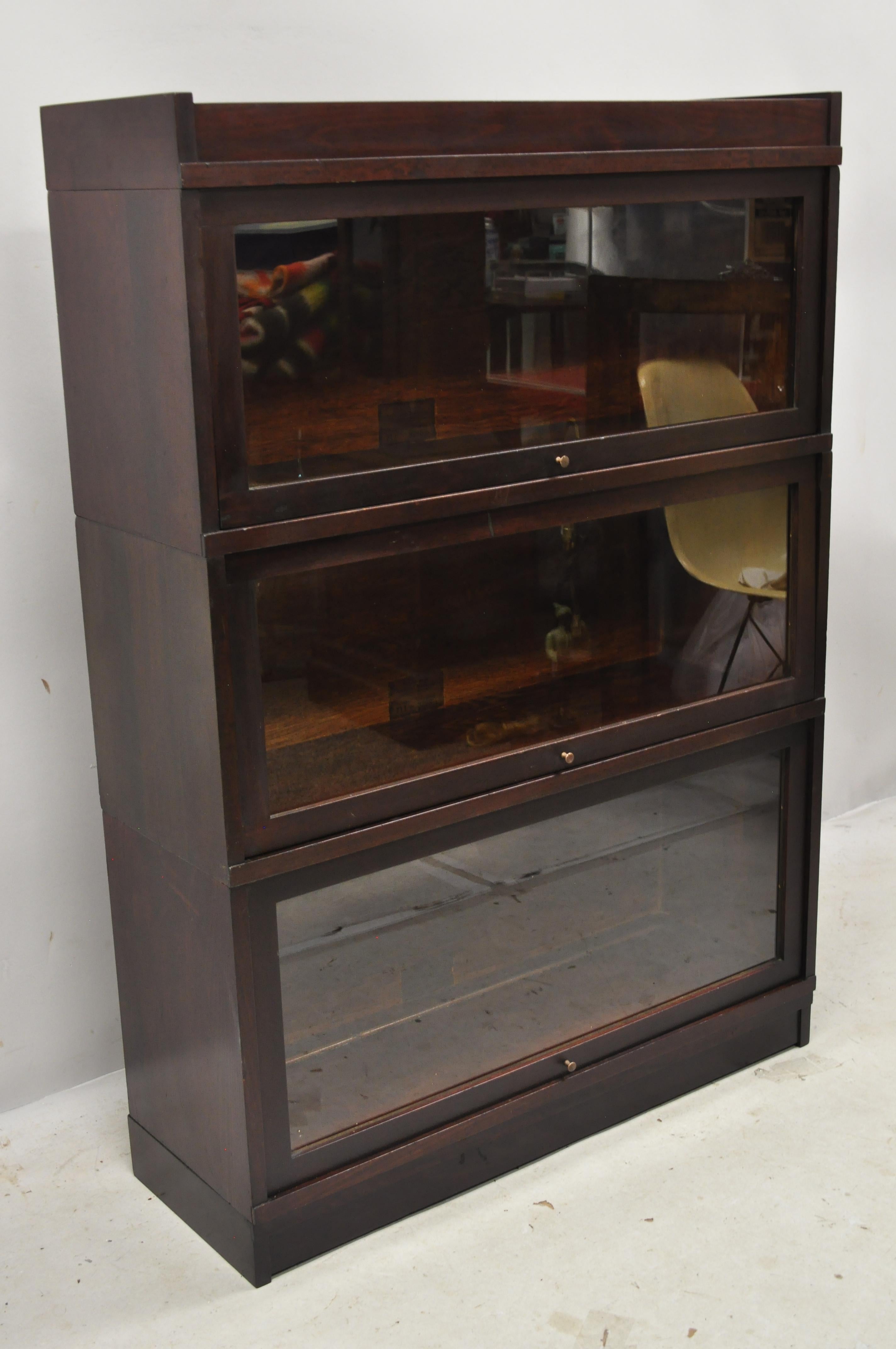 Antique Globe Wernicke mahogany stacking 3 section Barrister Lawyers bookcase. Item features 3 stacking sections, glass sliding doors, beautiful wood grain, original labels, very nice antique item, great style and form, circa early to mid-20th