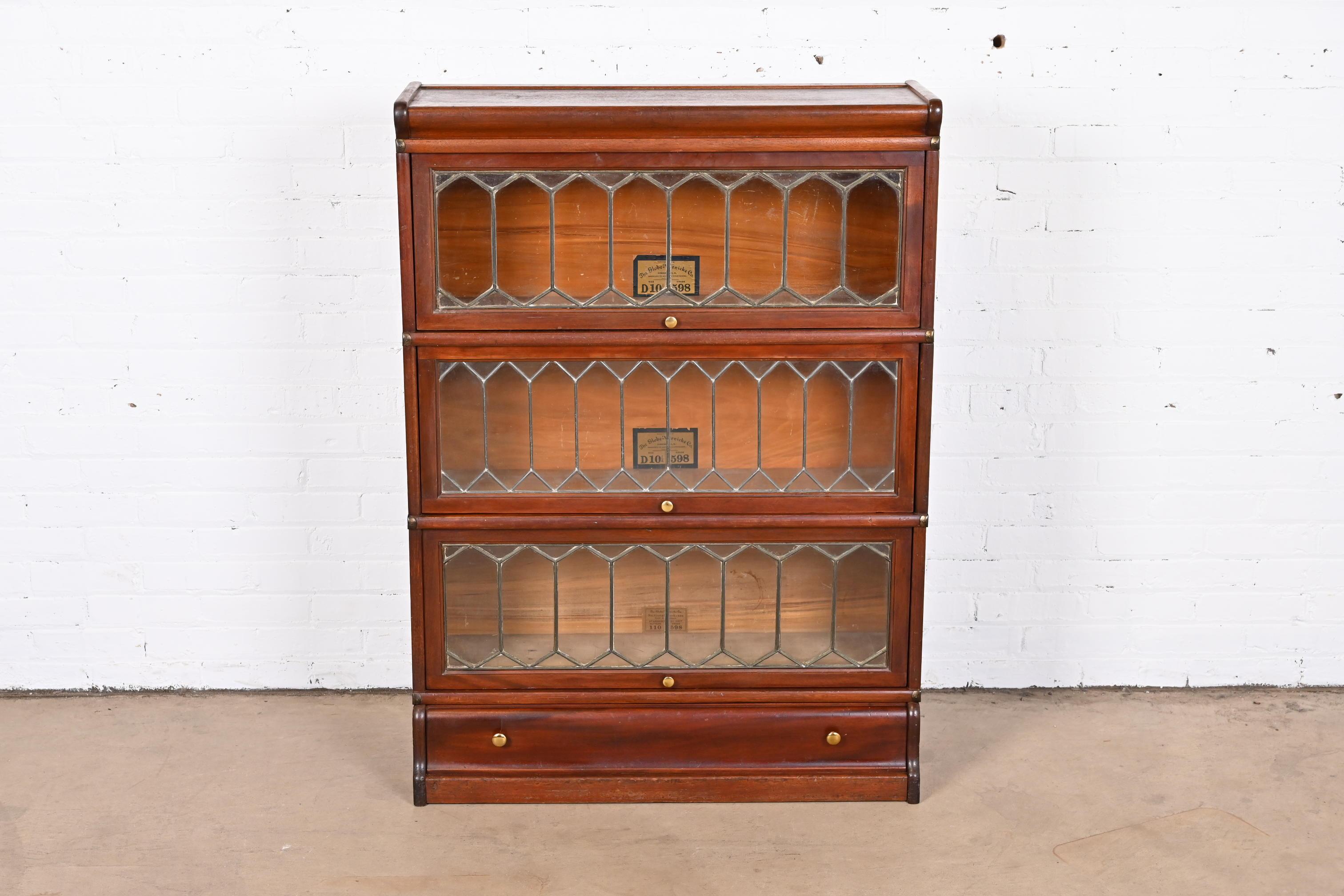 A gorgeous antique Arts & Crafts three-stack barrister bookcase

By Globe Wernicke

USA, Circa 1900

Mahogany, with leaded glass doors and original brass hardware.

Measures: 34