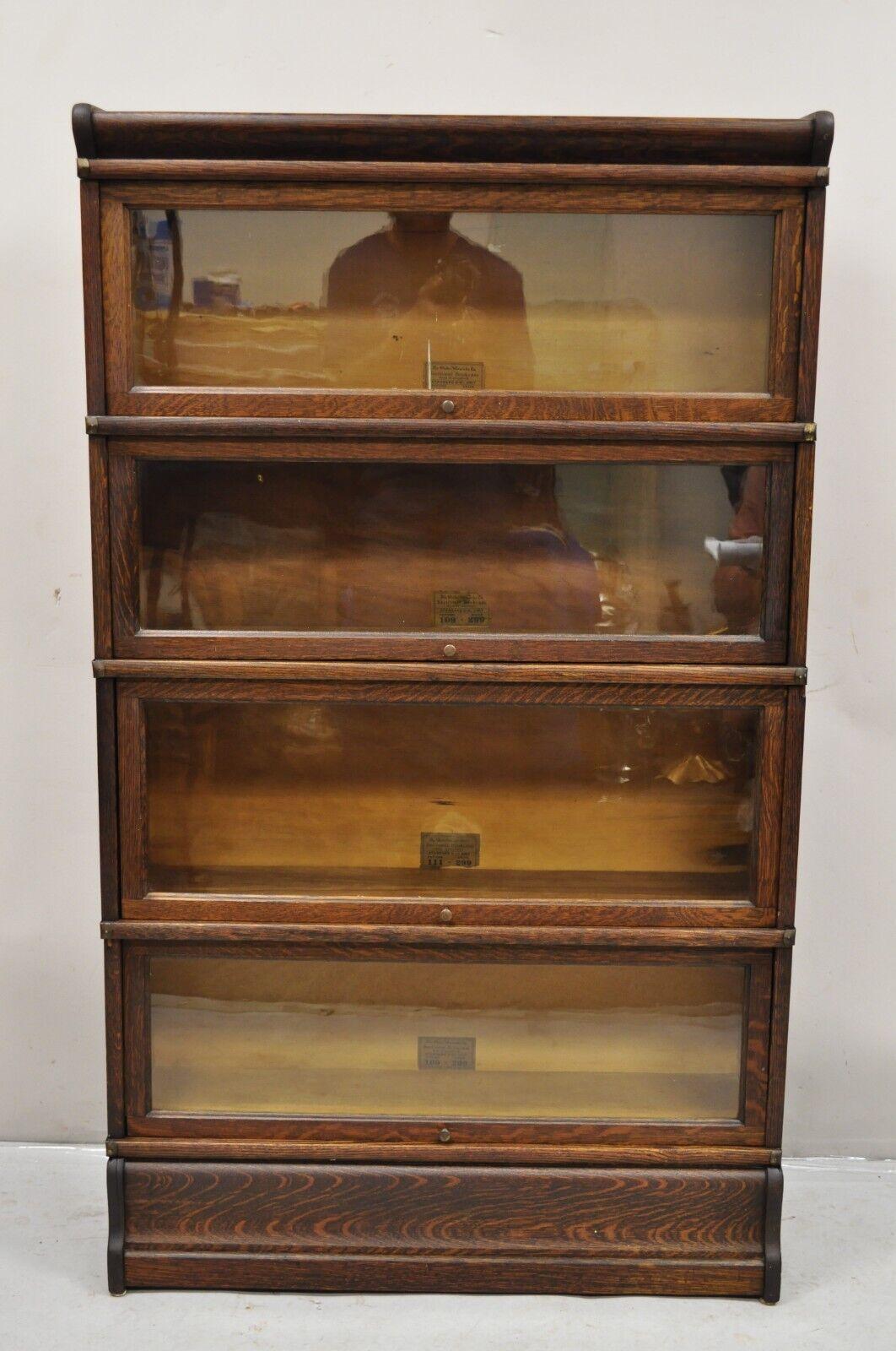 Antique Globe Wernicke Quartersawn Oak Four Section Stacking Barrister Bookcase. Item features (4) sections, (1) top, (1) bottom, original labels, (3) sections labeled pattern 109 grade 299, (1) labeled pattern 111 grade 299, very nice antique set.