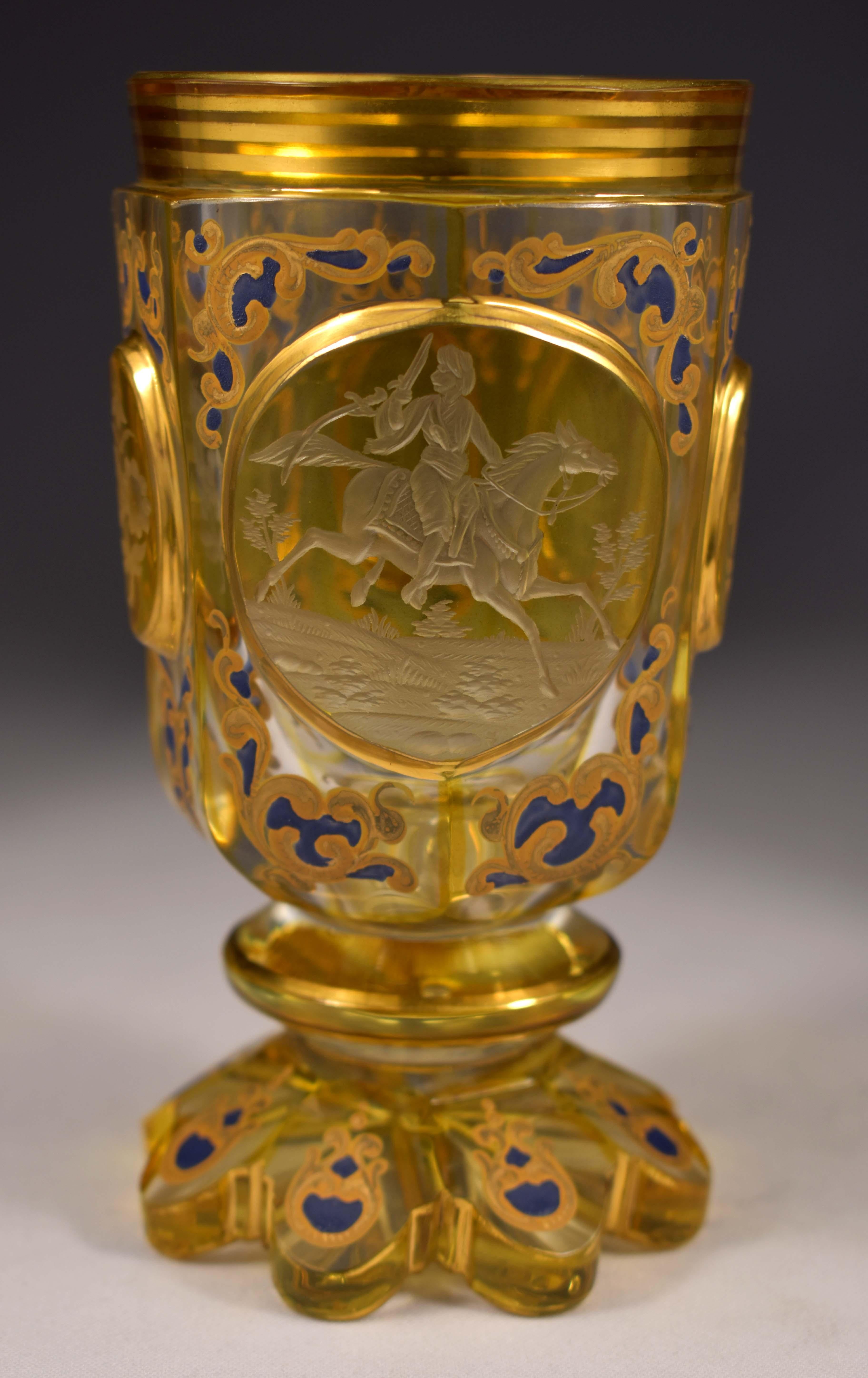 A beautiful cut engraved and painted goblet, Cut edges and medallions, clear glass with yellow lazure, The medallions have engravings, floral motifs and a monogram, The central medallion has an engraving depicting an armed mamluk on horseback.