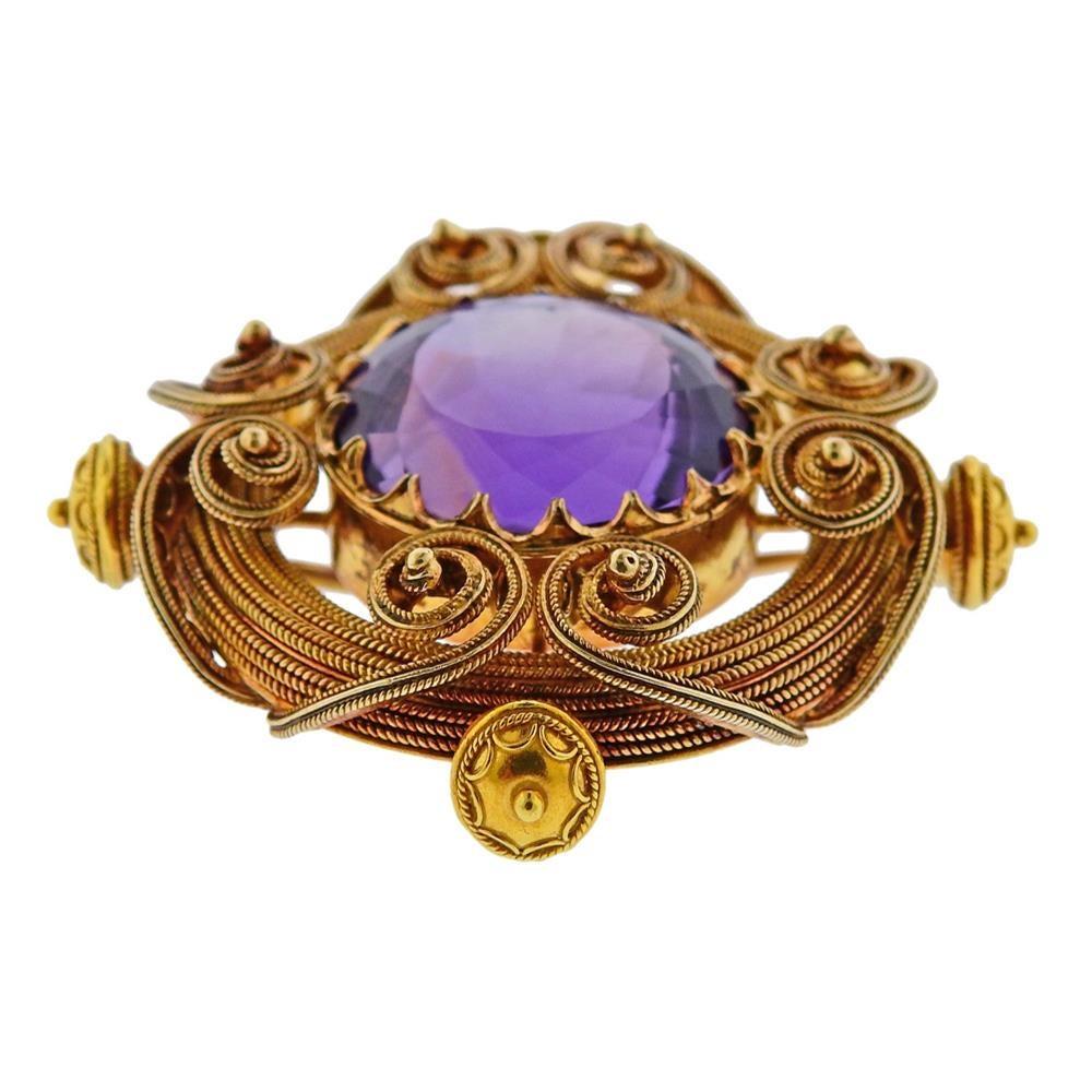 18k yellow gold antique brooch, set with approx. 21.5 x 18.2 x 13.5mm amethyst. Brooch measures 50mm x 47mm. Tested 18k. Weighs 30.2 grams.
