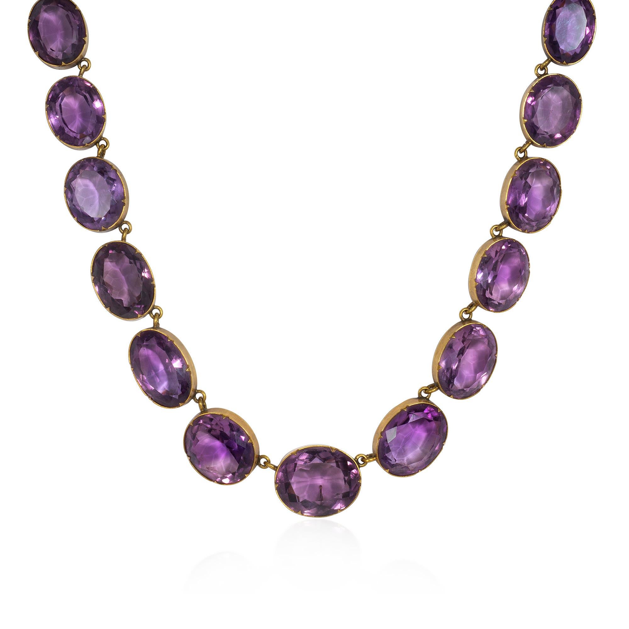 An antique Victorian period gold and amethyst rivière-style necklace composed of bezel-set oval amethysts suspending a detachable oversized oblong pendant, in 15k.  England.  Accompanied by the original box

Approximately 16