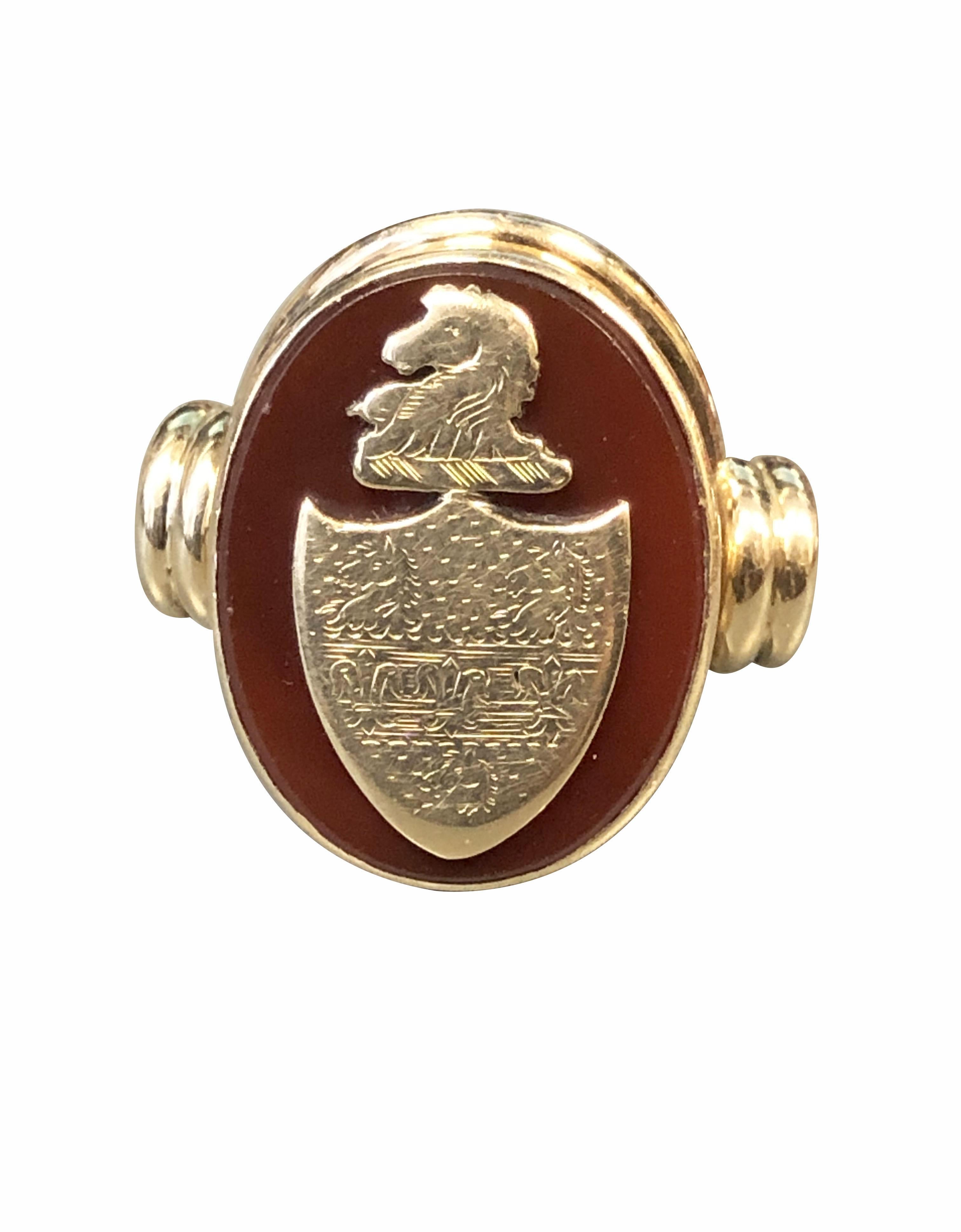 Circa 1900 14k Yellow Gold Signet Ring, the top measures 7/8 X 5/8 inch, set with a Carnelian stone with a Gold Signet Crest Shield attached on top, finger size 12 